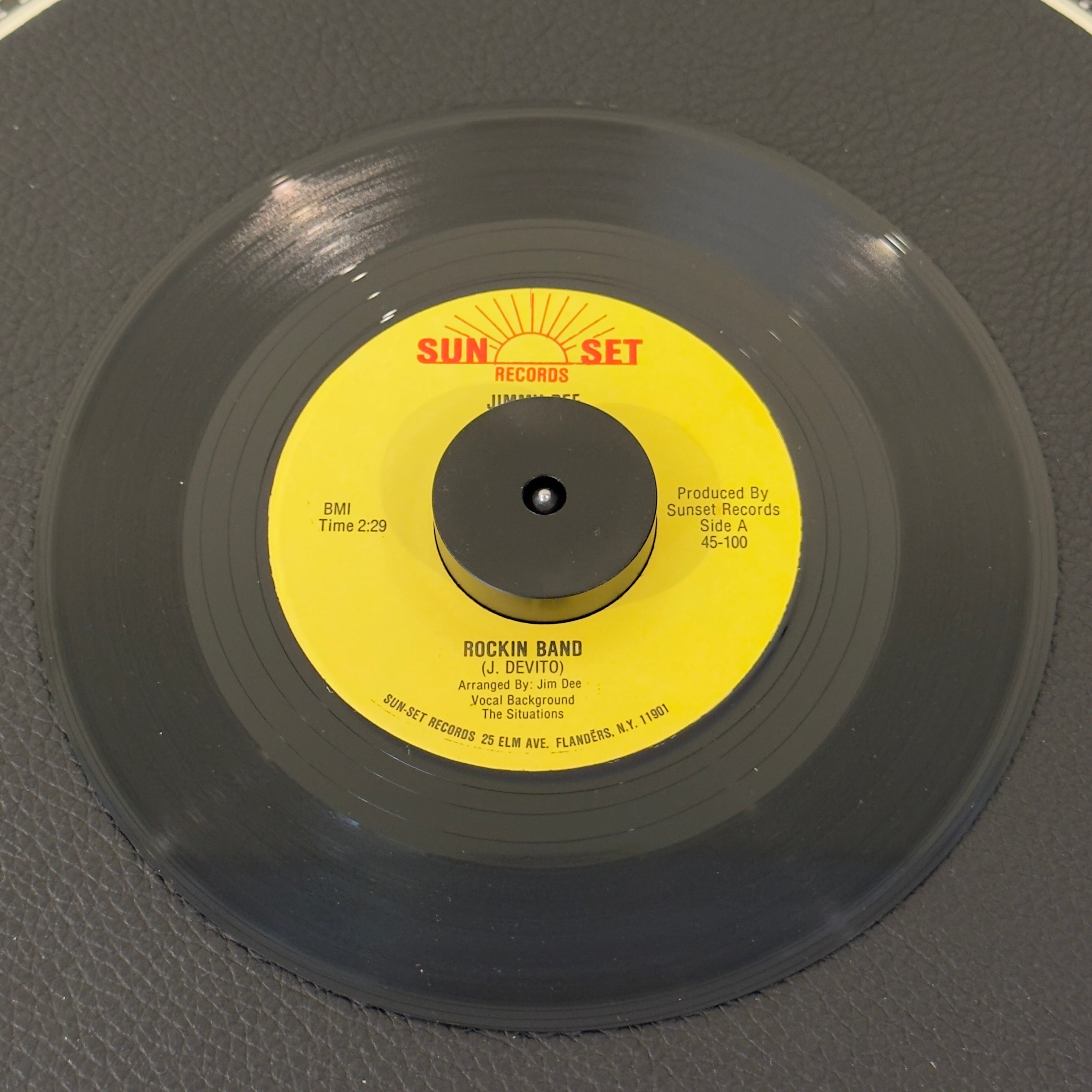 7" vinyl record by Jimmy Dee featuring "Rockin Band/My Way", released on Sunset Records (45-100), in VG+ (Very Good Plus) condition, classic analog collectable for turntable playback. Rare 1980s rockabilly 45!  Slight mark on B Side of label.