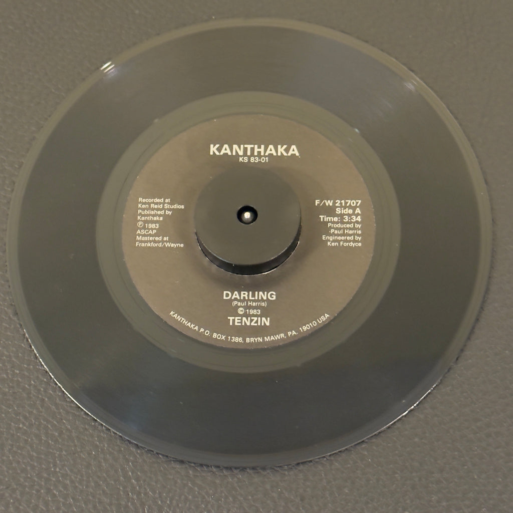 7" vinyl record by Tenzin featuring "Darling/Better Man", released on Kanthaka (F/W 21707), in VG+ (Very Good Plus) condition, classic analog collectable for turntable playback. Impossibly rare 1983 Private Press Country-Rock Americana 45.  A true ghost-rarity, completley unmapped, unrleased to streaming 7" vinyl.