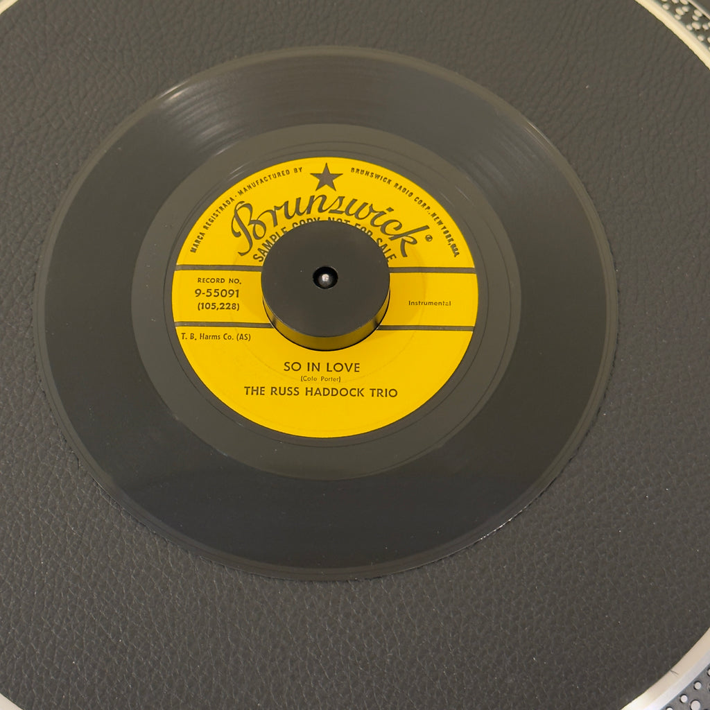 7" vinyl record by Russ Haddock Trio, The featuring "So In Love/Mohican", released on Brunswick (9-55091), in NM (Near Mint) condition, classic analog collectable for turntable playback. Promotional Copy! A near mint 1958 space-age jazz gem!