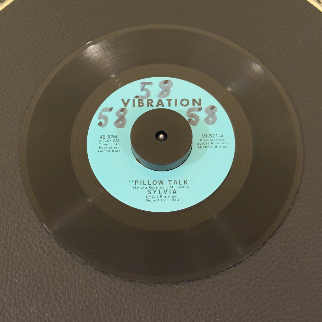 7" vinyl record by Sylvia featuring "Pillow Talk/My Thing", released on Vibration (VI-521), in VG+ (Very Good Plus) condition, classic analog collectable for turntable playback. Writing on Side A of the label.