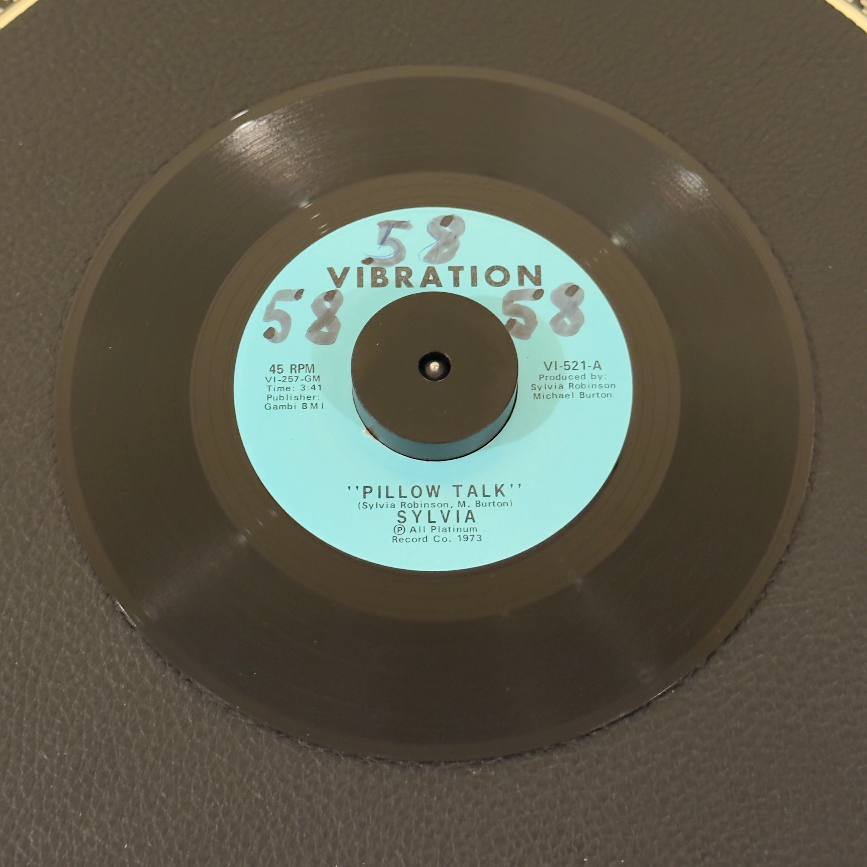 7" vinyl record by Sylvia featuring "Pillow Talk/My Thing", released on Vibration (VI-521), in VG+ (Very Good Plus) condition, classic analog collectable for turntable playback. Writing on Side A of the label.