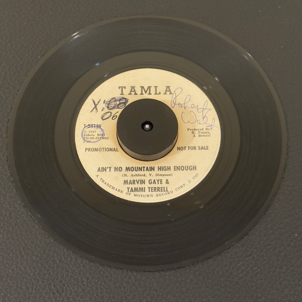7" vinyl record by Marvin Gaye & Tammi Terrell featuring "Ain't No Mountain High Enough", released on Tamla (T-54149), in G+ (Good Plus) condition, classic analog collectable for turntable playback. Super Rare Promotional Copy!!!!!  Writing on both sides of label & a sticker on one side. Plays great.