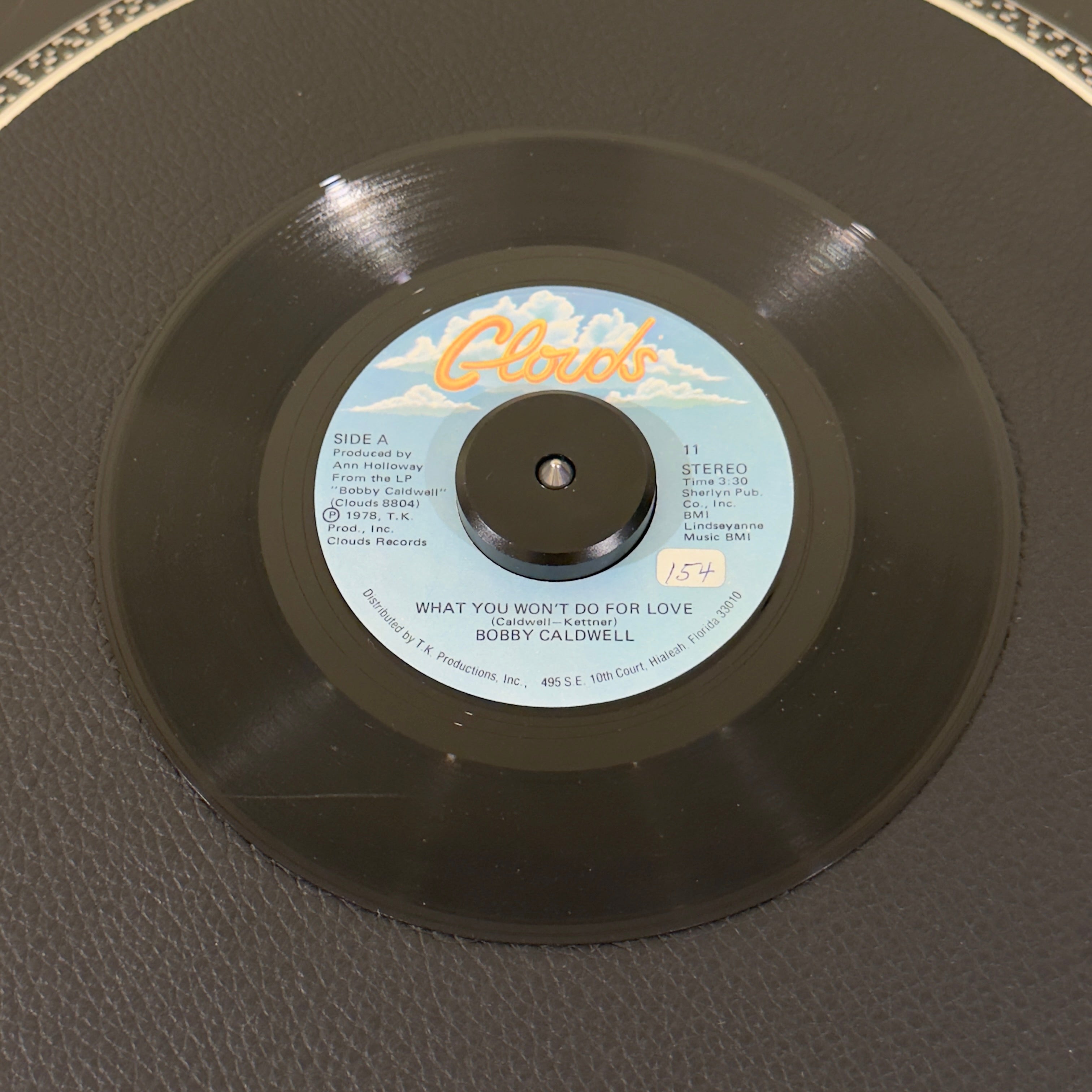 7" vinyl record by Bobby Caldwell featuring "What You Won't Do For Love/Love Won't Wait", released on Disco (11), in VG (Very Good) condition, classic analog collectable for turntable playback. Undisputed banger sampled by various artists, inlcuding 2Pac & Aailiyah. Sticker on Side A.