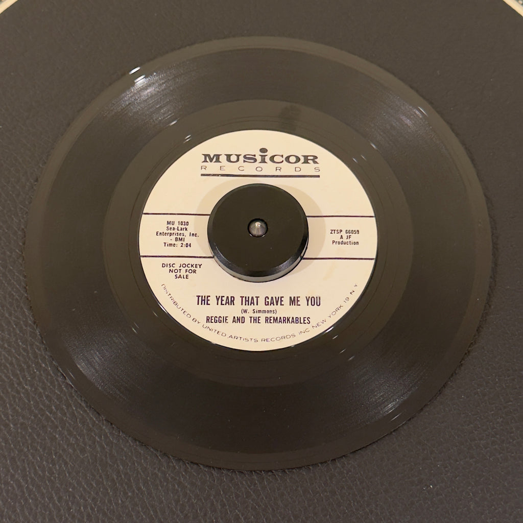 7" vinyl record by Reggie & The Remarkables featuring "The Year That Gave Me You/Come On Baby", released on Musicor Records (MU1030), in VG (Very Good) condition, classic analog collectable for turntable playback. Promo copy of the highly elusive East Coast doo-wop harmony gem in a Musicorp sleeve!