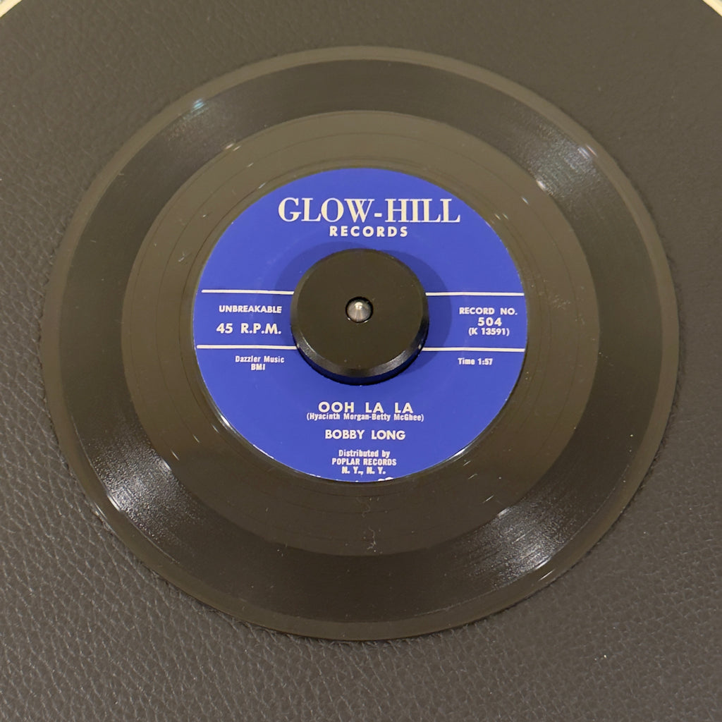 7" vinyl record by Bobby Long featuring "Ooh La La/Hold Me", released on Glow-Hill Records (504), in NM (Near Mint) condition, classic analog collectable for turntable playback. Stunning, archive-worthy copy of Bobby Long's highly sought-after 1959 Doo Wop staple, "Ooh La La".