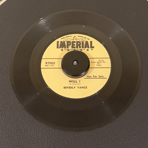 7" vinyl record by Beverly Vance featuring "Will I/In The Chapel", released on Imperial Records (X7002), in VG+ (Very Good Plus) condition, classic analog collectable for turntable playback. Promo copy-time-capsule piece of late-1950s American rockabilly and teen pop history!  Includes original Imperial sleeve.