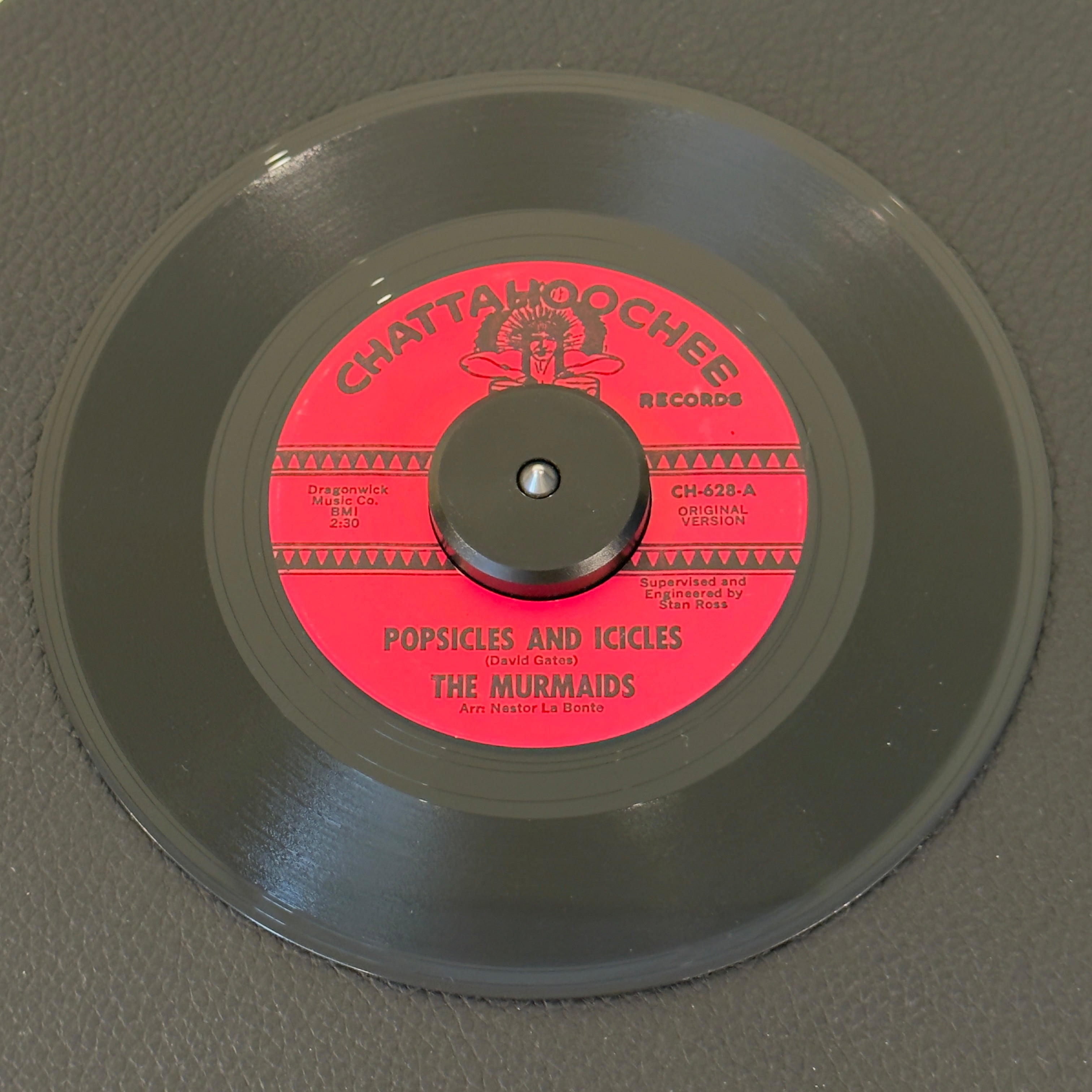 7" vinyl record by Murmaids, The featuring "Popsicles And Icicles/Blue Dress", released on Chattahoochee Records (CH628), in VG+ (Very Good Plus) condition, classic analog collectable for turntable playback. Girl-group masterwork that reached #3 on the Billboard charts in 1964.