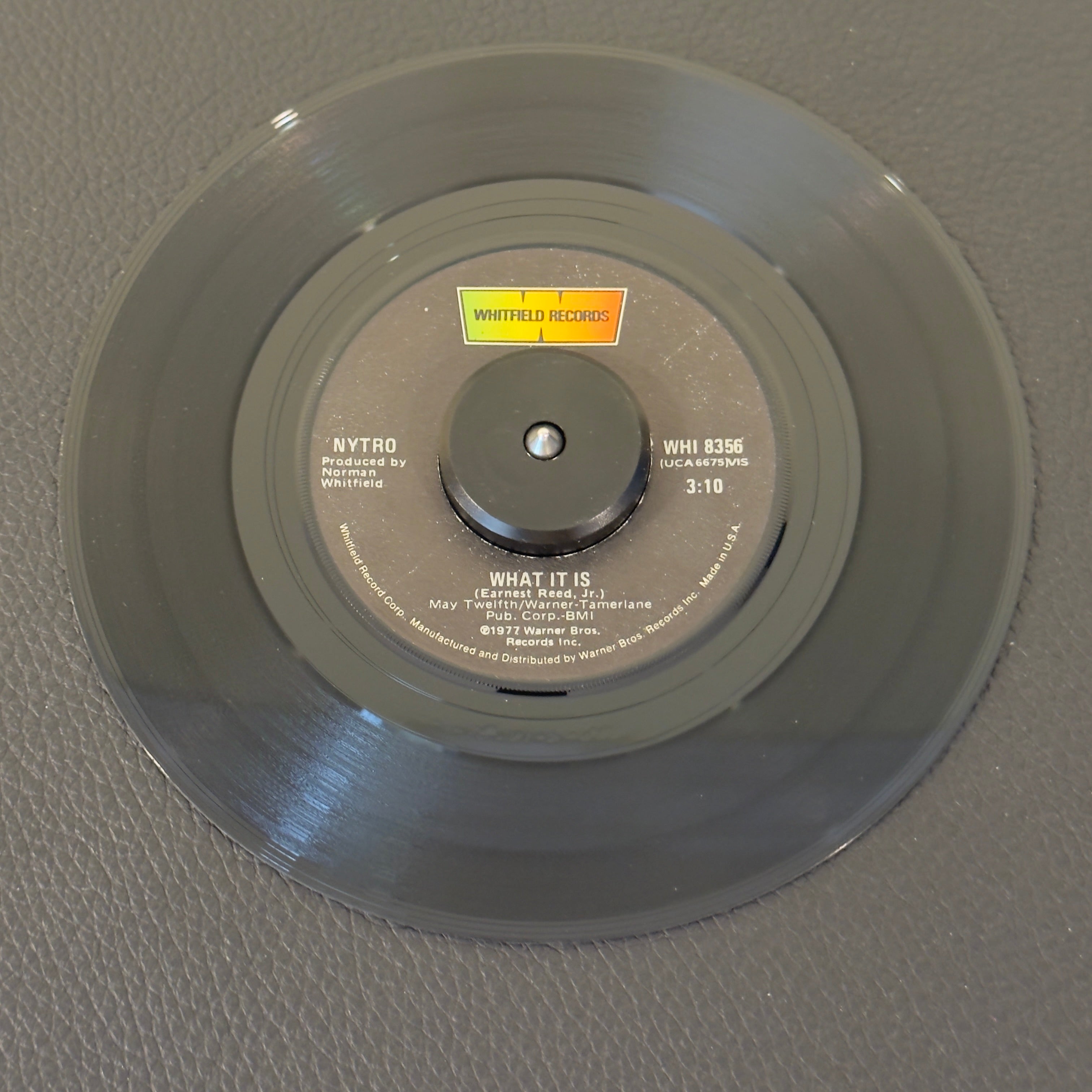 7" vinyl record by Nytro featuring "What It Is/Give Me One More Chance", released on Whitfield Records (WHI 8356), in VG+ (Very Good Plus) condition, classic analog collectable for turntable playback. Heavy, space-age 1970s groove, produced by Motown icon Norman Whitfield on his own boutique label.