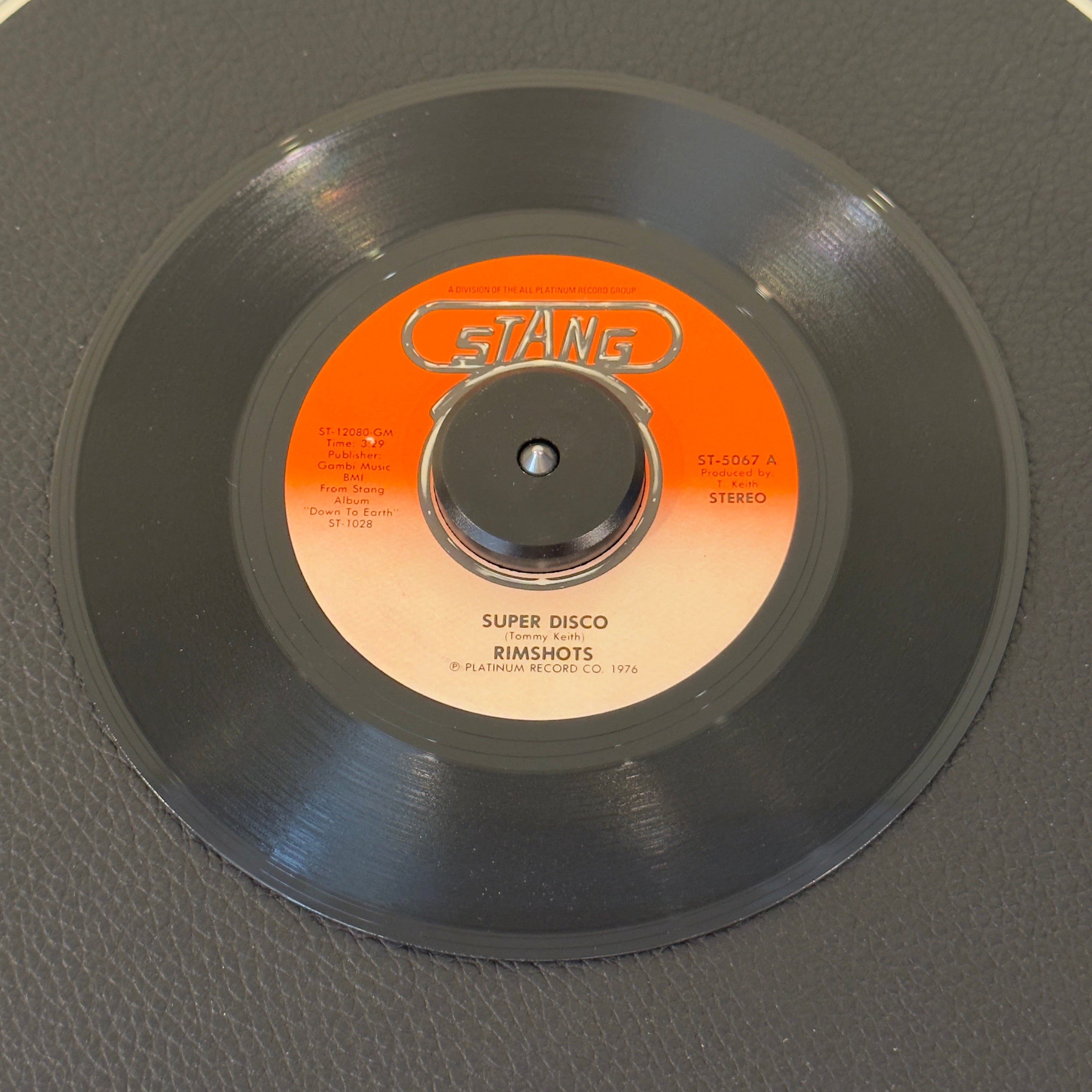 7" vinyl record by Rimshots featuring "Super Disco/Groove Bus", released on Stang Records (ST-5067), in NM (Near Mint) condition, classic analog collectable for turntable playback. A breakbeat-laden funk storm packed with driving percussion, tight horn stabs, and an infectious bassline.