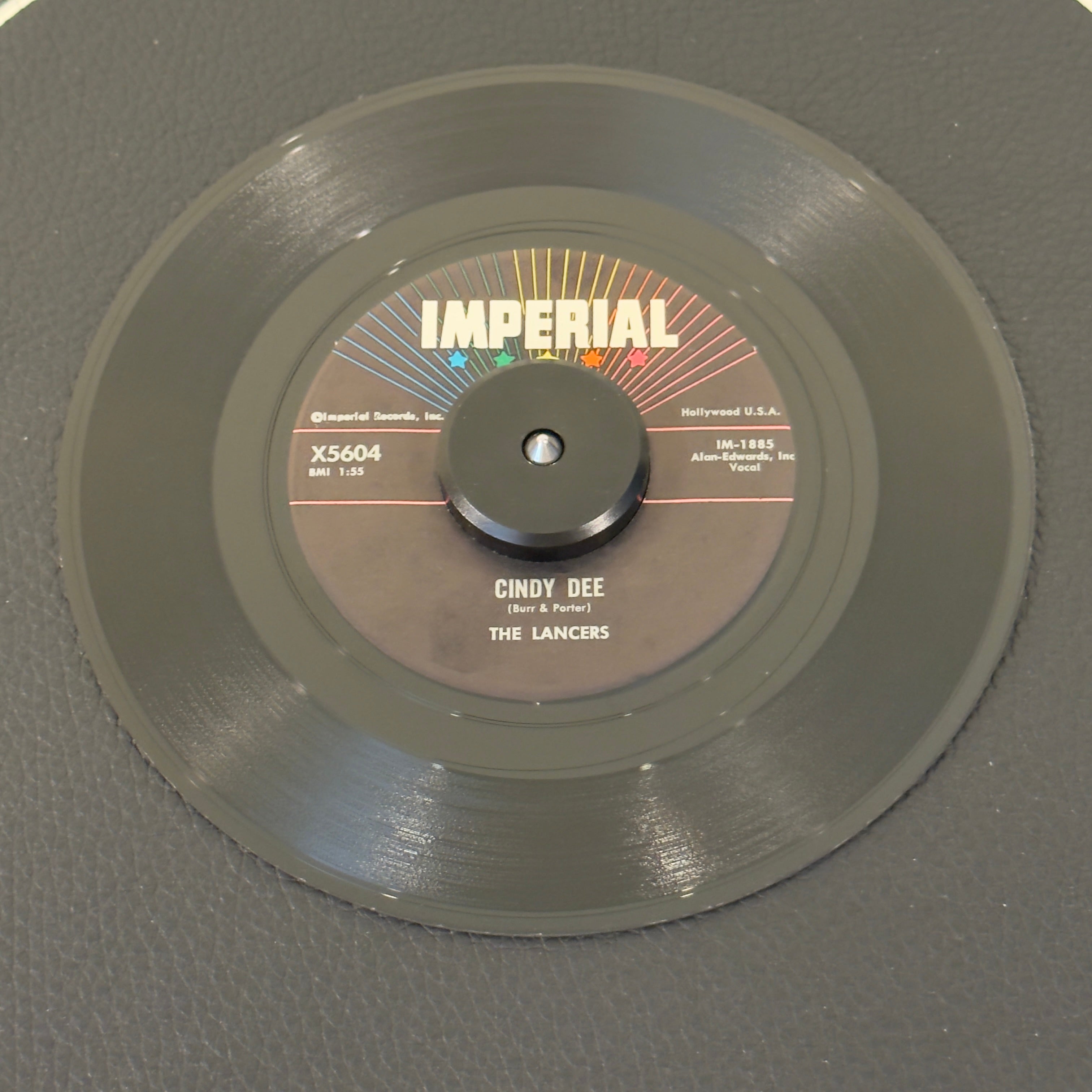 7" vinyl record by Lancers, The featuring "Cindy Dee/Ah Sweet Mystery Of Life", released on Imperial (X5604), in VG+ (Very Good Plus) condition, classic analog collectable for turntable playback. 1959 US pressing features the group's signature tight vocal arrangements and polished, swinging rhythm backing.  Includes original Imperial sleeve.