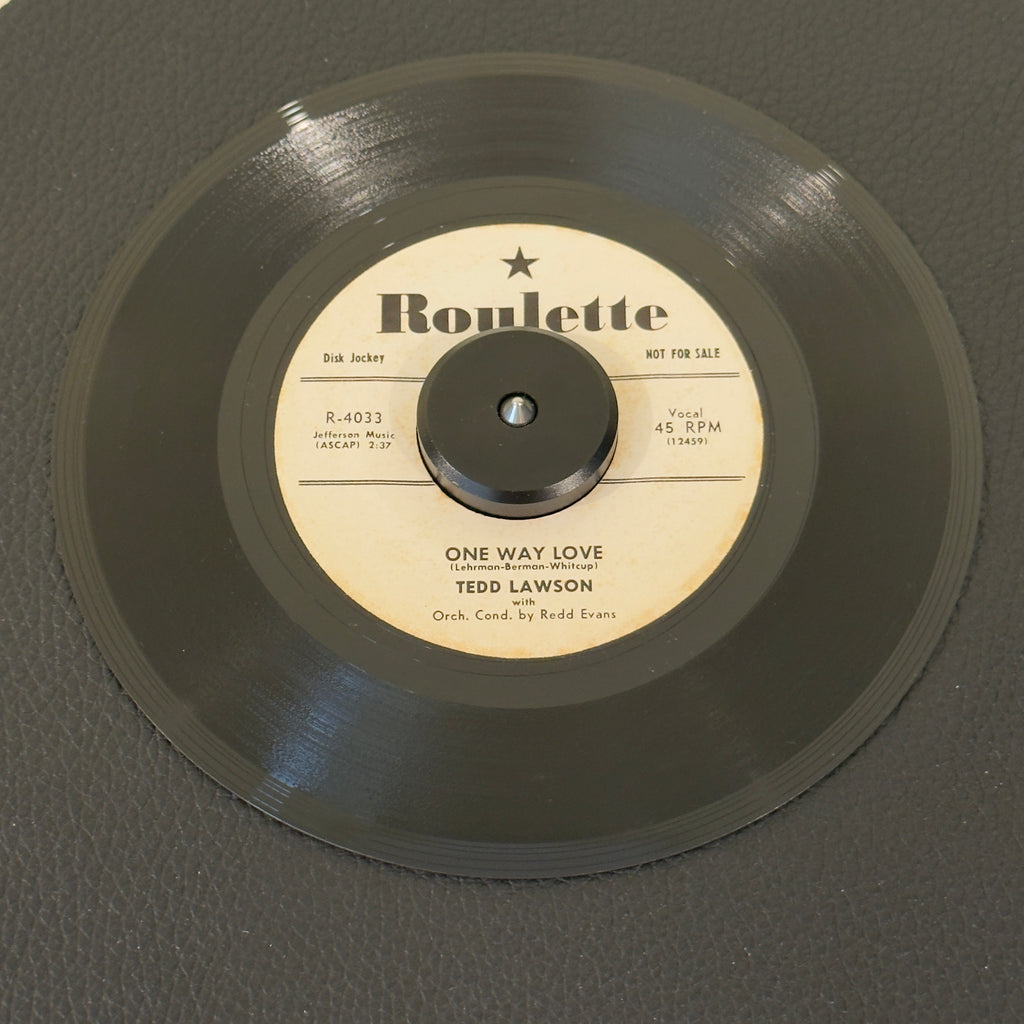 7" vinyl record by Ted Lawson featuring "One Way Love/Wasteland", released on Roulette (R-4033), in VG+ (Very Good Plus) condition, classic analog collectable for turntable playback. 1957 US white-label promotional pressing released during the foundational first year of legendary New York imprint Roulette Records.  Includes original sleeve.