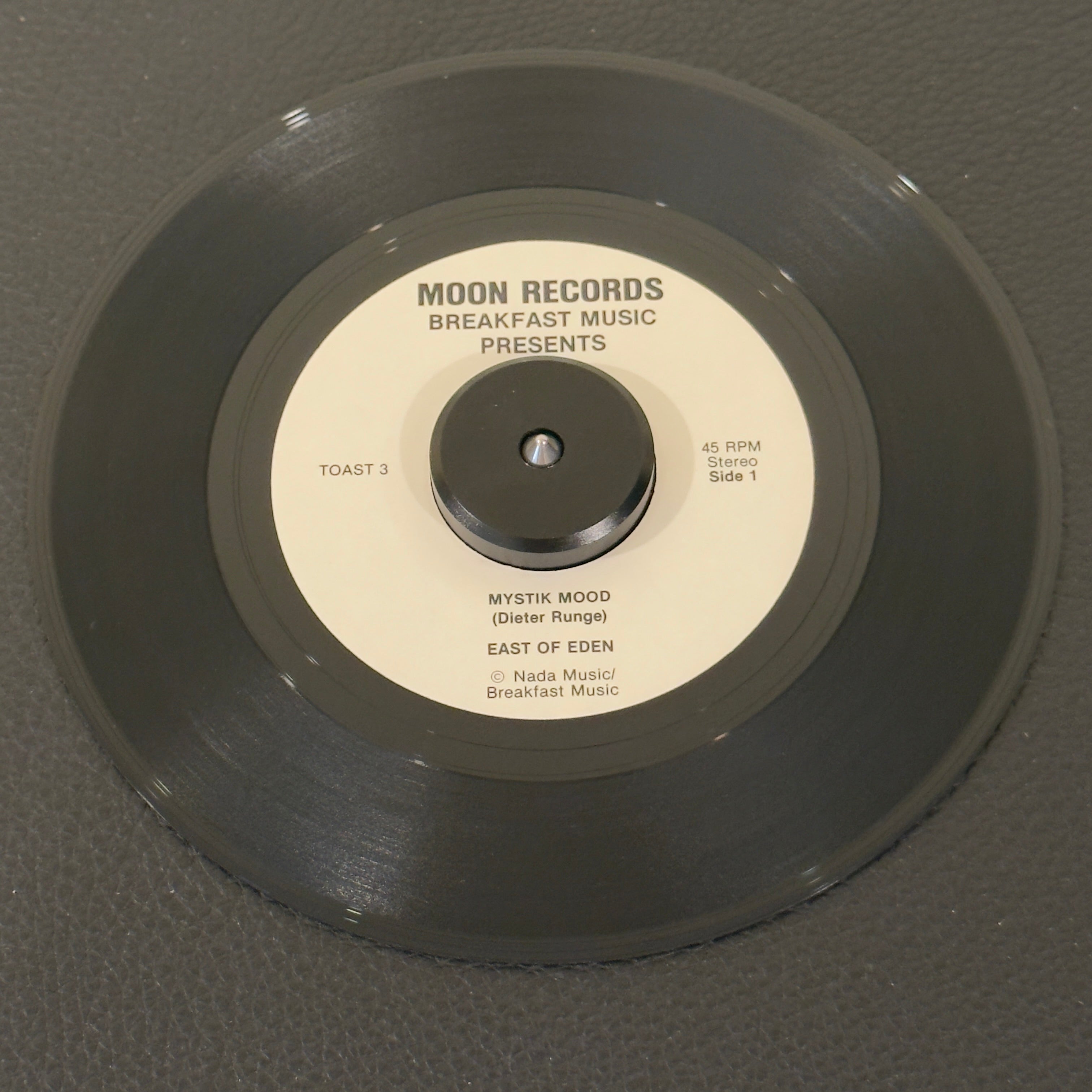 7" vinyl record by East of Eden featuring "Mystik Mood/Sea Of Happiness", released on Moon Records (Toast 3 / Toast 4), in VG+ (Very Good Plus) condition, classic analog collectable for turntable playback. 1984 incredibly rare slice of Lower East Side music history. Pic sleeve included. Only 1,000 copies were pressed.
