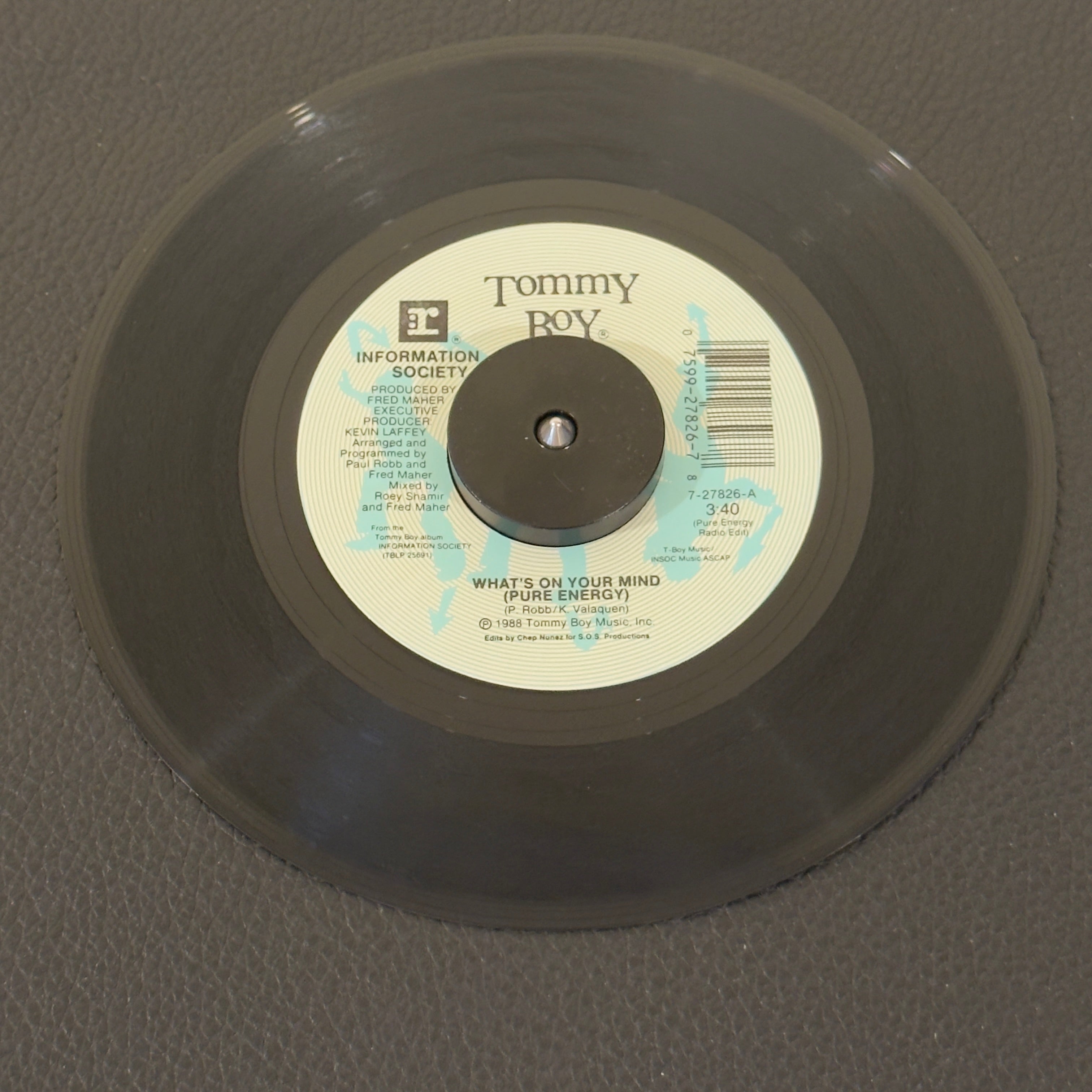7" vinyl record by Information Society featuring "What's On Your Mind (Pure Energy) (Pure Energy Radio Edit)/(Club Radio Edit)", released on Tommy Boy (7-27826), in VG+ (Very Good Plus) condition, classic analog collectable for turntable playback. Defining synth-pop anthem of the late-80s club scene. Famously featuring vocal samples of Leonard Nimoy's Spock from Star Trek. Pic Sleeve.