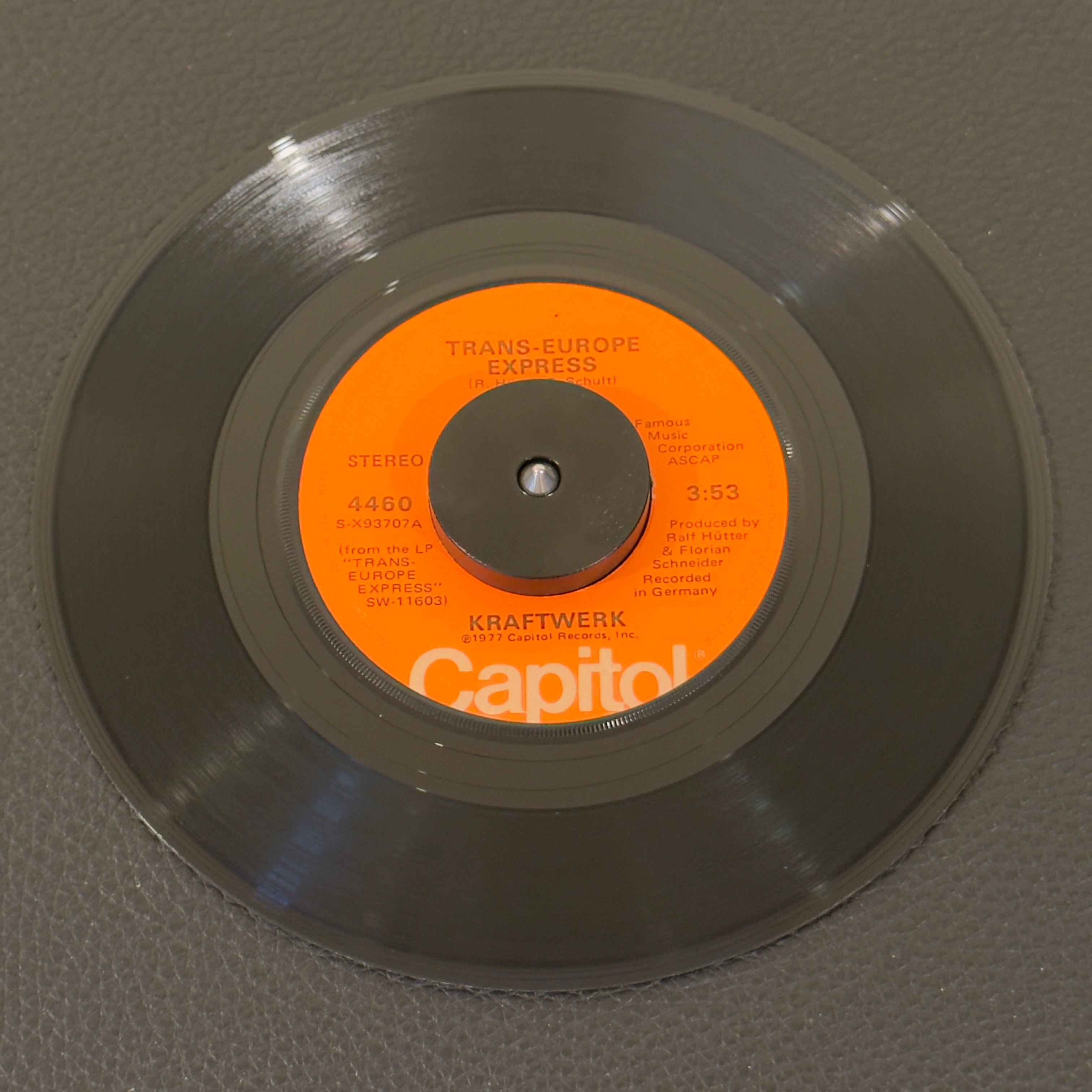 7" vinyl record by Kraftwerk featuring "Trans-Europe Express/Franz Schubert", released on Capitol Records (4460), in VG+ (Very Good Plus) condition, classic analog collectable for turntable playback. Serving as the DNA for numerous songs!  Sampled by Afrika Bambaataa in Planet Rock, De La Soul, Dr Dre & Lil Wanye just to name a few.