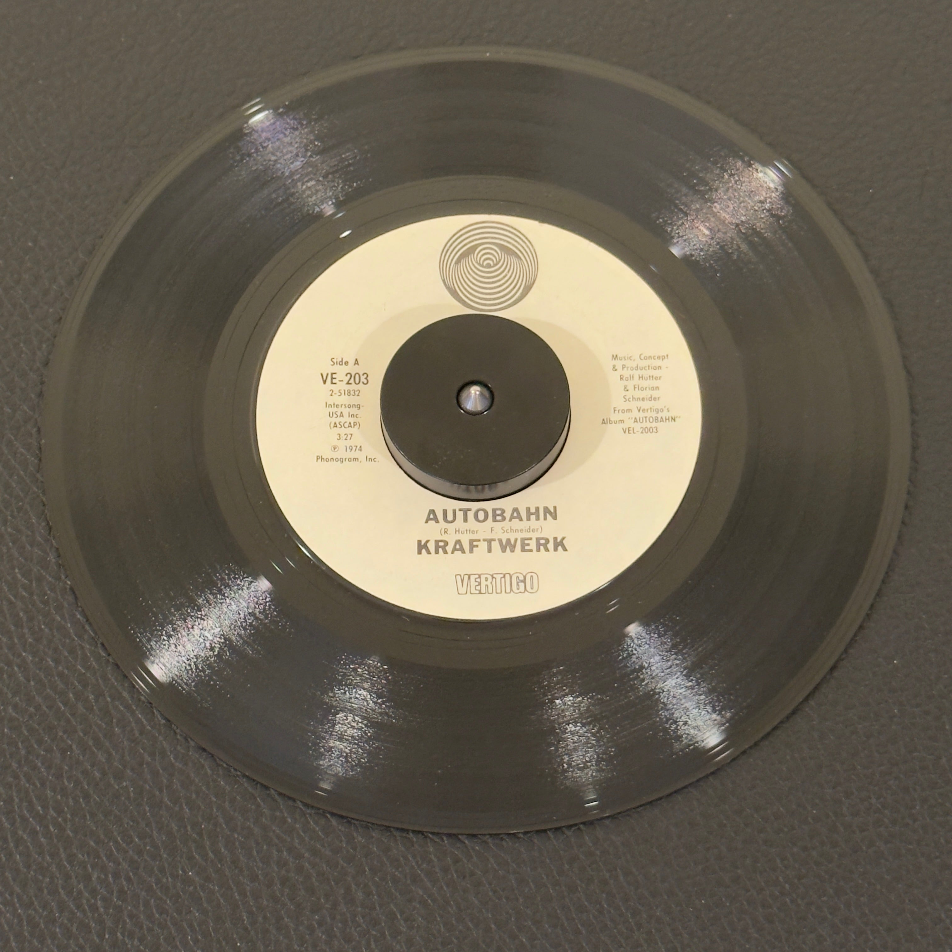 7" vinyl record by Kraftwerk featuring "Autobahn/Morgenspaziergang = Morning Walk", released on Vertigo (VE-203), in VG+ (Very Good Plus) condition, classic analog collectable for turntable playback. US pressing of the historic single that helped bring electronic music into the pop mainstream. Kraftwerk’s very first track to integrate sung vocals alongside their modular synthesizers.