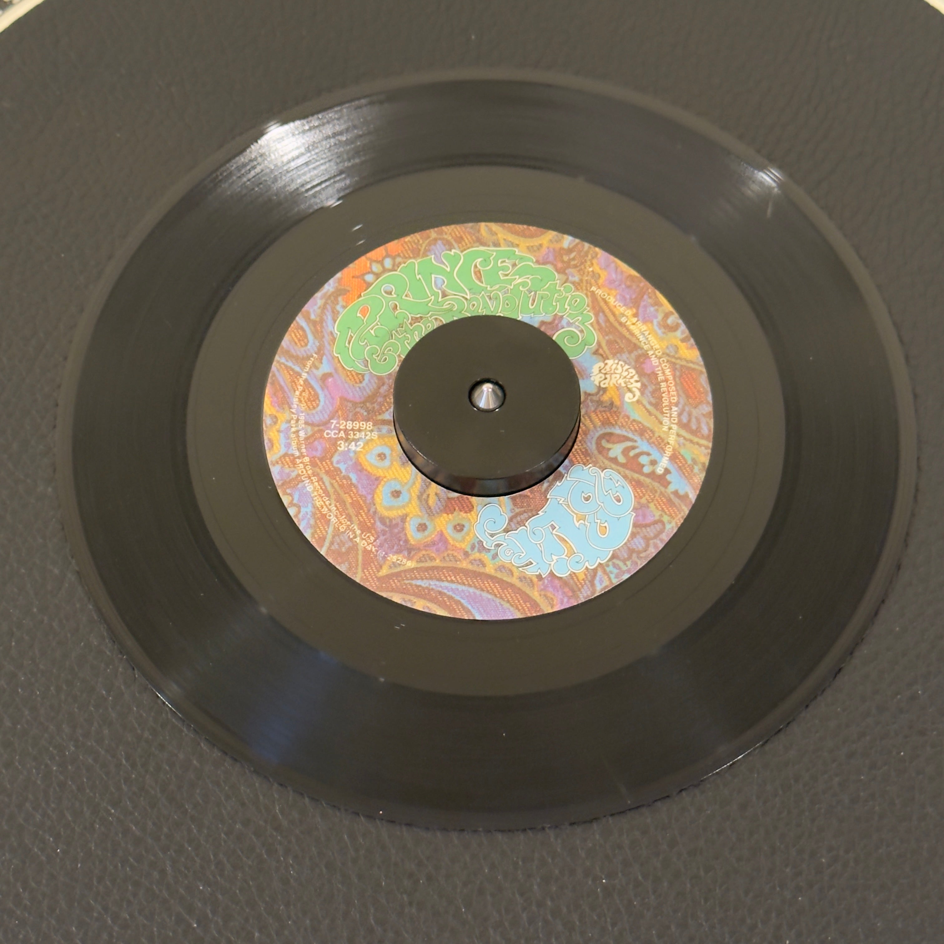 7" vinyl record by Prince And The Revolution featuring "Pop Life/Hello", released on Paisley Park (7-28998), in VG (Very Good) condition, classic analog collectable for turntable playback. A must have for anyone's collection.