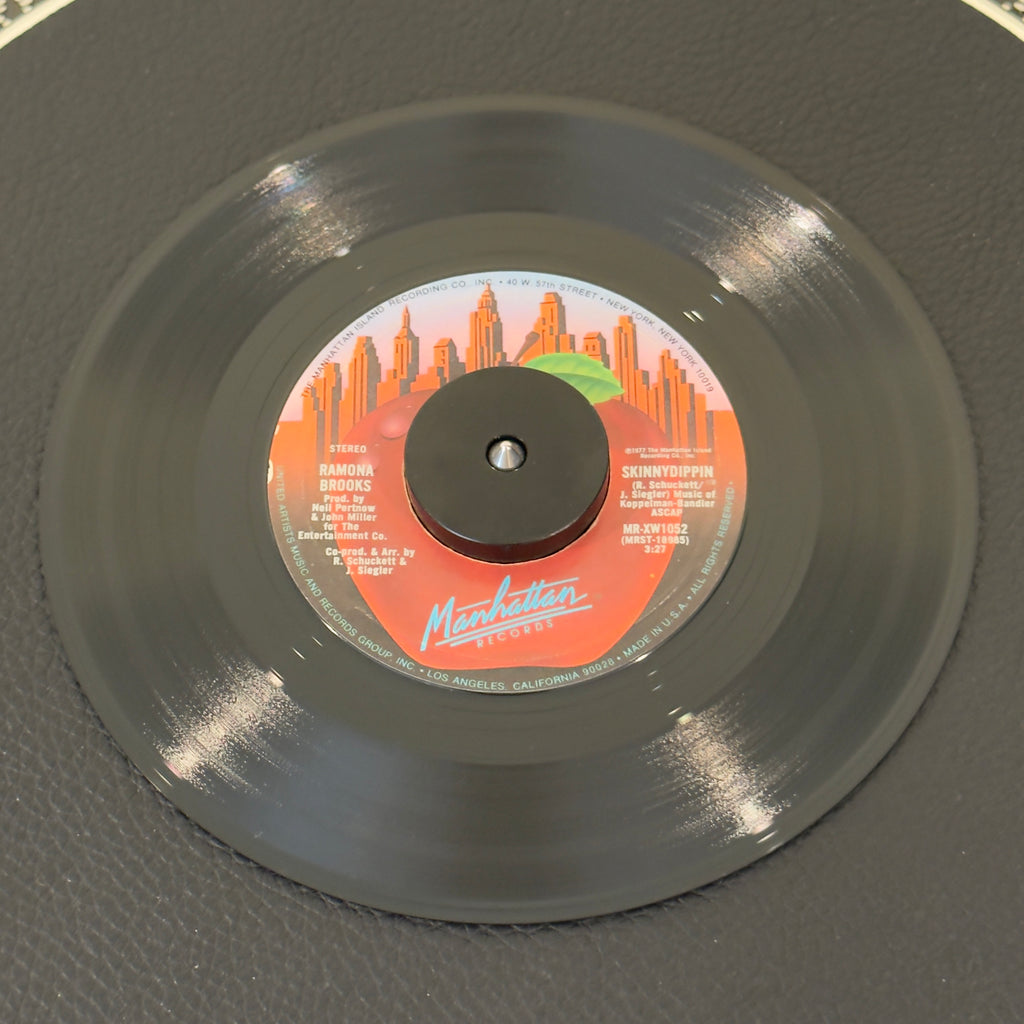 7" vinyl record by Ramona Brooks featuring "Skinnydippin/Rhythm Rhapsody", released on Manhattan Records (MR-XW1052), in NM (Near Mint) condition, classic analog collectable for turntable playback. Produced by Bunny Sigler and arranged by the great Ron Kersey.