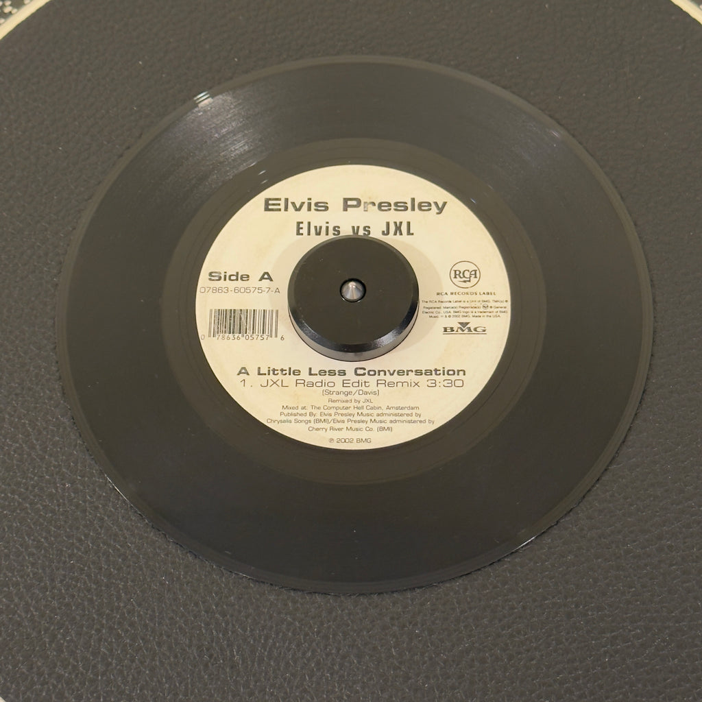 7" vinyl record by Elvis Presley Vs JXL featuring "A Little Less Conversation (JXL Radio Edit Remix)/Original Version", released on RCA Records (07863-60575-7), in VG+ (Very Good Plus) condition, classic analog collectable for turntable playback. 2002 crossover anthem that introduced Elvis Presley to a completely new generation! Originally mixed by JXL for a Nike World Cup commercial.