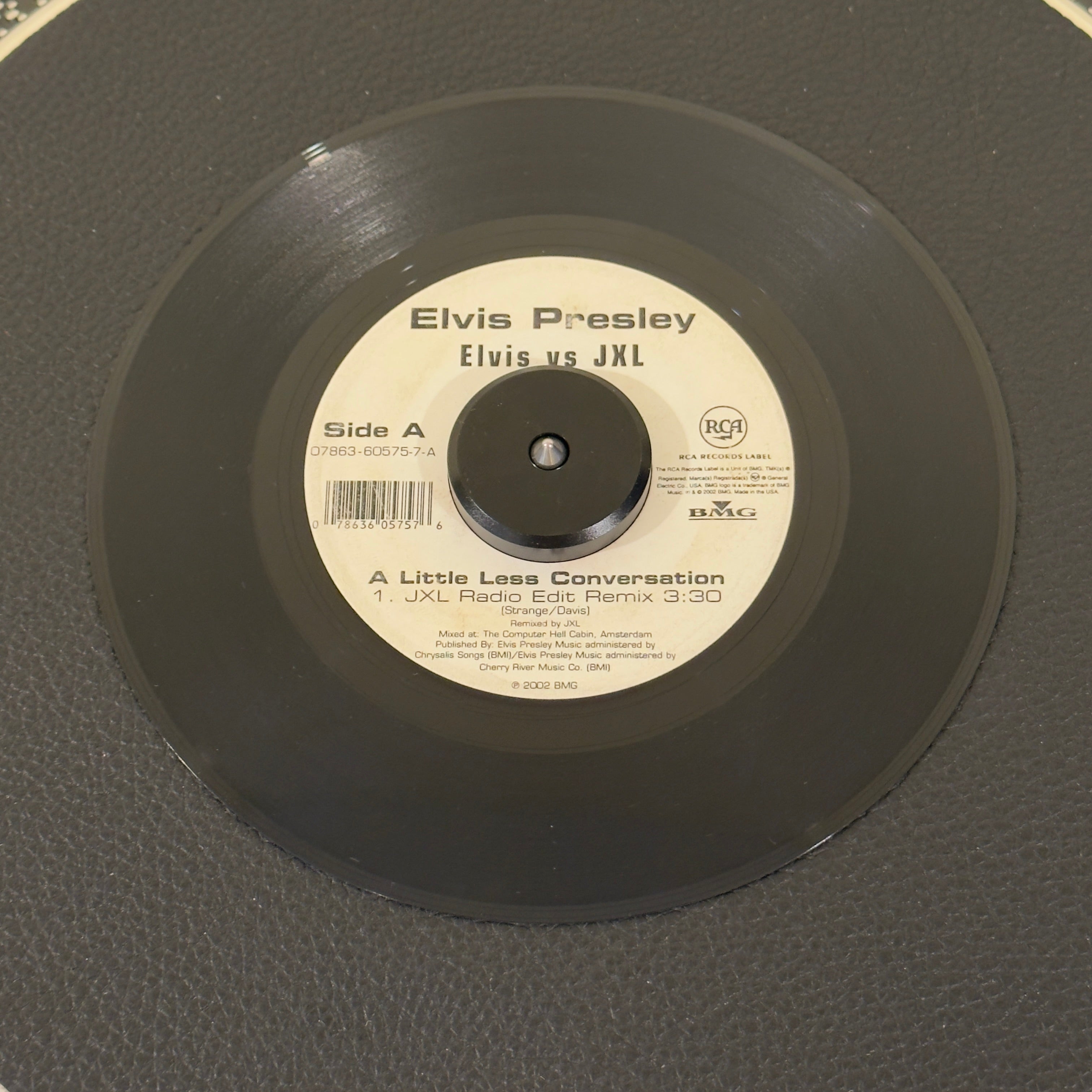 7" vinyl record by Elvis Presley Vs JXL featuring "A Little Less Conversation (JXL Radio Edit Remix)/Original Version", released on RCA Records (07863-60575-7), in VG+ (Very Good Plus) condition, classic analog collectable for turntable playback. 2002 crossover anthem that introduced Elvis Presley to a completely new generation! Originally mixed by JXL for a Nike World Cup commercial.
