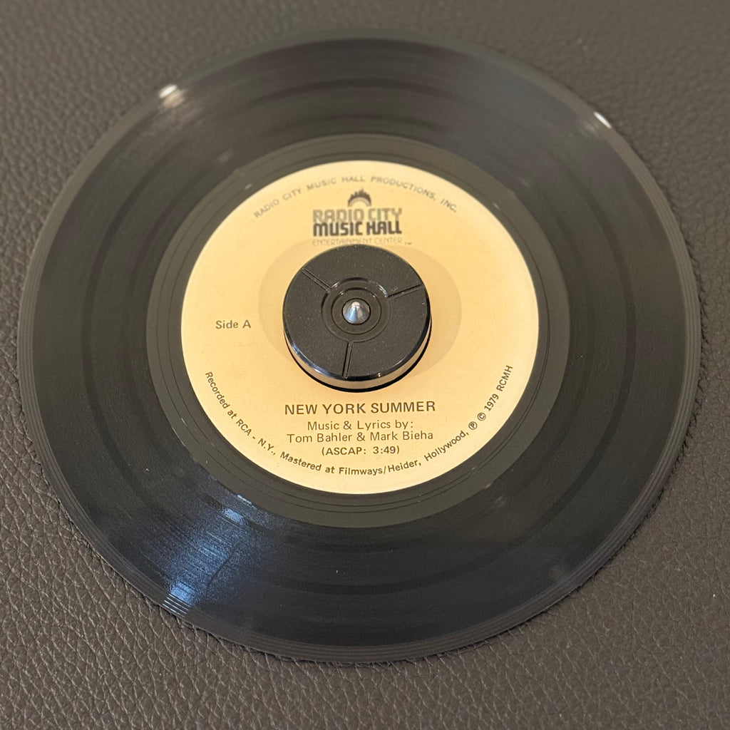 7" vinyl record by Unknown Artist featuring "New York Summer/I Thank Heaven", released on Radio City Music Hall (RS 2208), in VG+ (Very Good Plus) condition, classic analog collectable for turntable playback. Promo Copy. Music and lyrics by Tom Bahler and Quincy Jones.