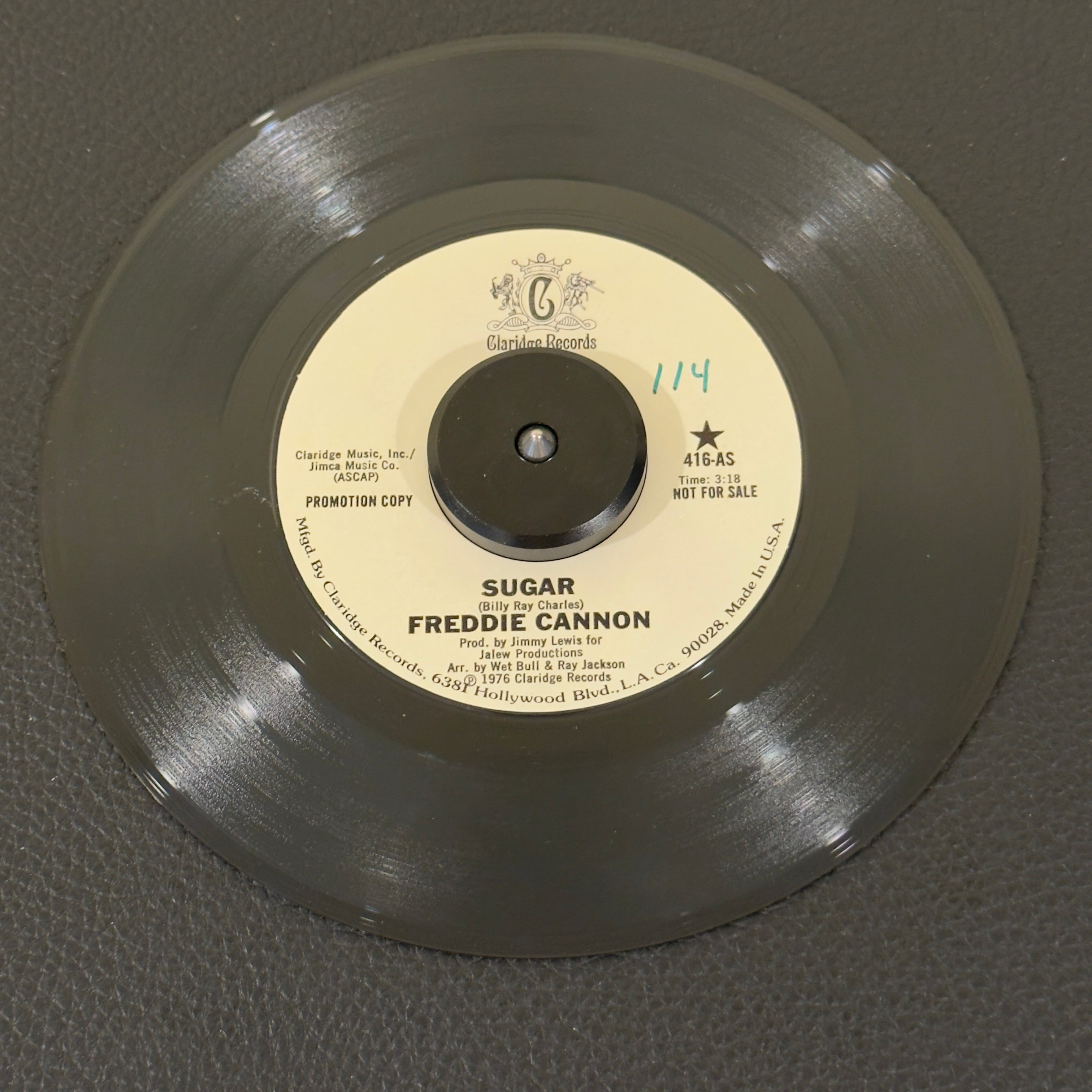 7" vinyl record by Freddie Cannon featuring "Sugar/Sugar (Part Two)", released on Claridge Records (416), in VG+ (Very Good Plus) condition, classic analog collectable for turntable playback. Promo copy that features Cannon masterfully adapting his signature explosive vocal energy to an infectious, horn-heavy mid-70s funk and soul backbeat. WOL