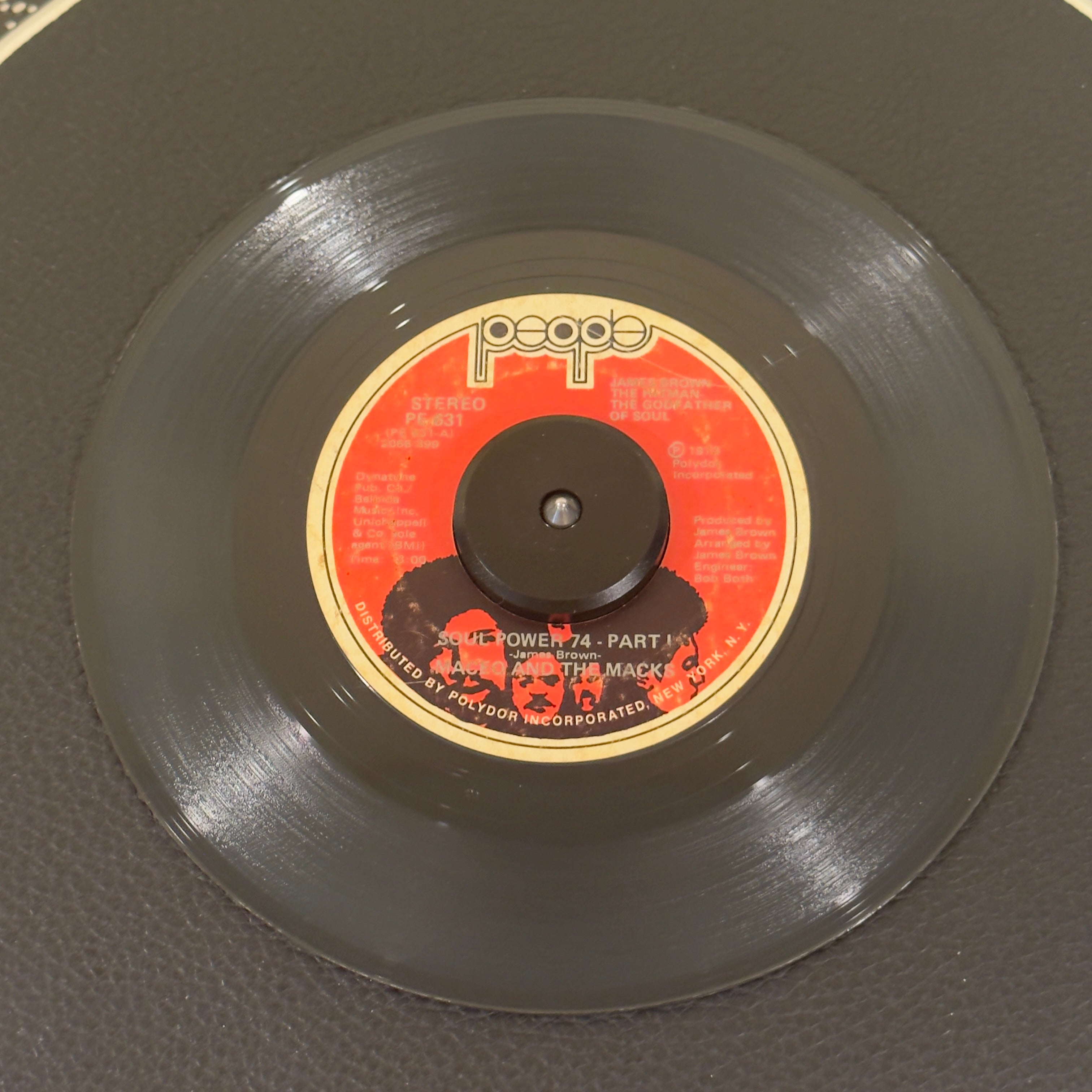 7" vinyl record by Maceo And The Macks featuring "Soul Power 74 - Part I/Part II", released on People (PE 631), in VG (Very Good) condition, classic analog collectable for turntable playback. Original 1973 first pressing of the essential funk double-sider features the highly desirable original red label layout.