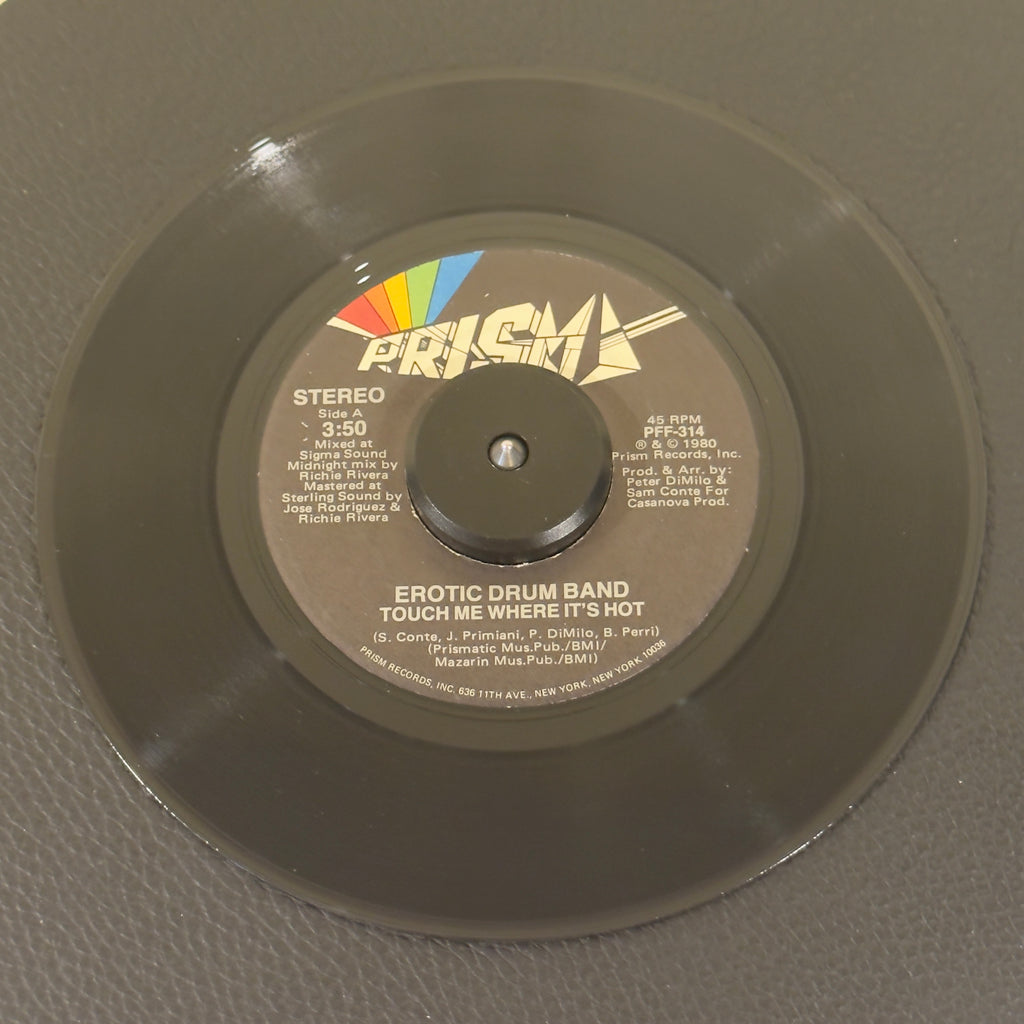 7" vinyl record by Erotic Drum Band featuring "Touch Me Where It's Hot/Dance In Your Pants", released on Prism (PFF-314), in NM (Near Mint) condition, classic analog collectable for turntable playback. Mixed at Sigma Sound Studios in NYC, and mastered at Sterling Sound, this 1980 release delivers a masterclass in percussion-heavy, driving dance music.