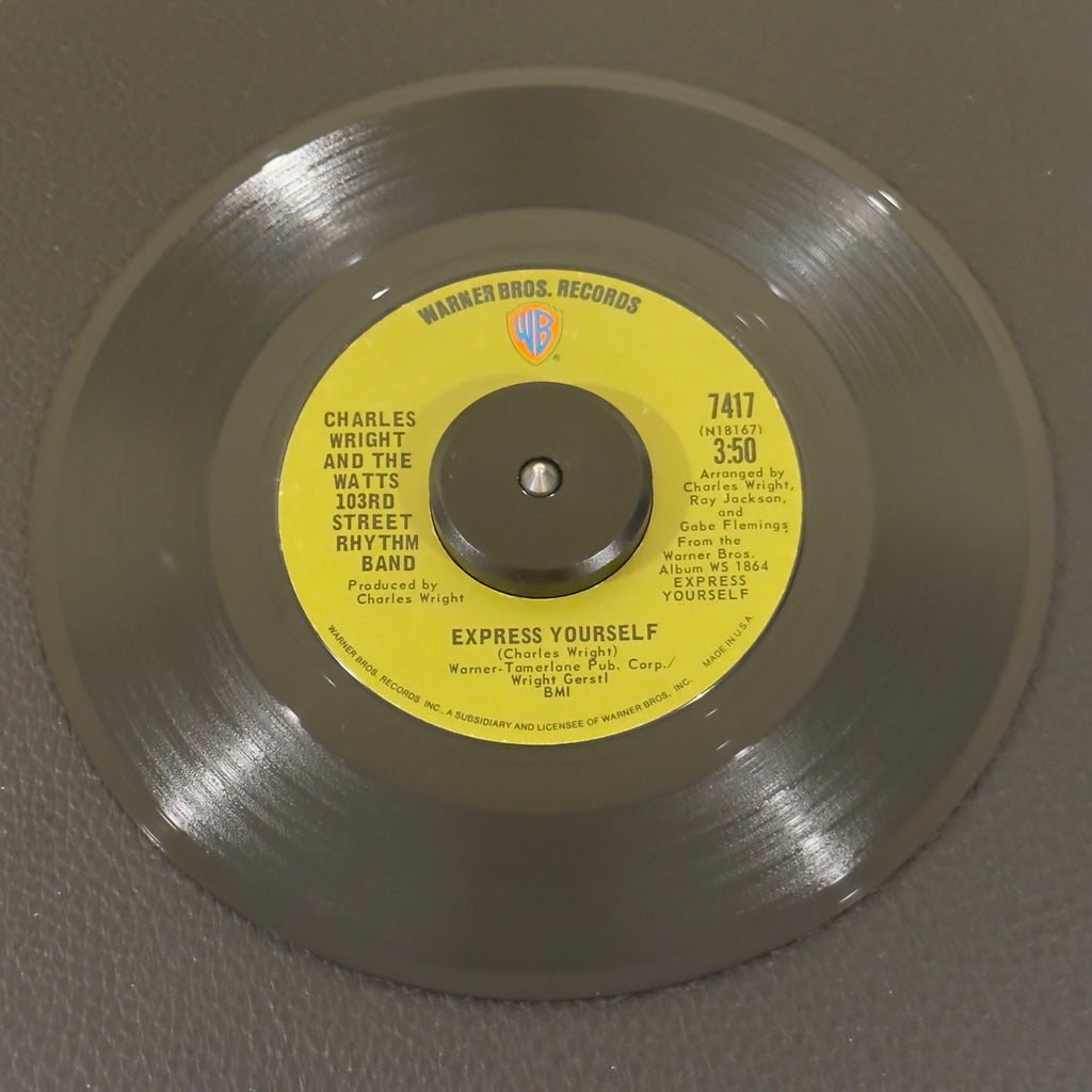 7" vinyl record by Charles Wright And The Watts 103rd Street Rhythm Band featuring "Express Yourself/Living On Borrowed Time", released on Warner Bros. Records (7417), in VG+ (Very Good Plus) condition, classic analog collectable for turntable playback. 1970 single featuring the timeless funk anthem which famously served as the foundation for N.W.A's iconic hip-hop track of the same name.