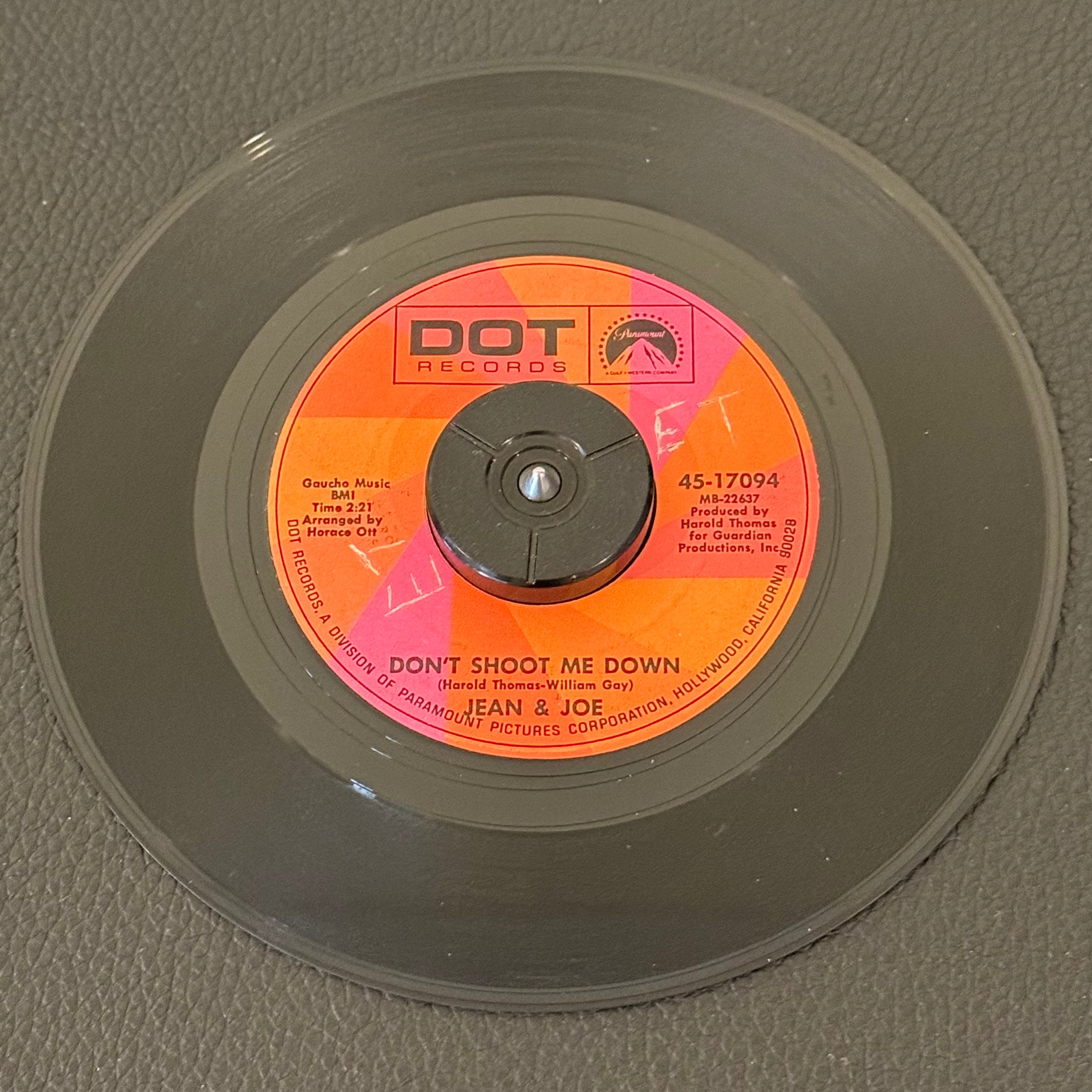 7" vinyl record by Jean & Joe featuring "Don't Shoot Me Down/Meant For Each Other "Yes Indeed"", released on Dot Records (45-17094), in VG (Very Good) condition, classic analog collectable for turntable playback. Includes DOT Records sleeve. Writing on both sides of label.