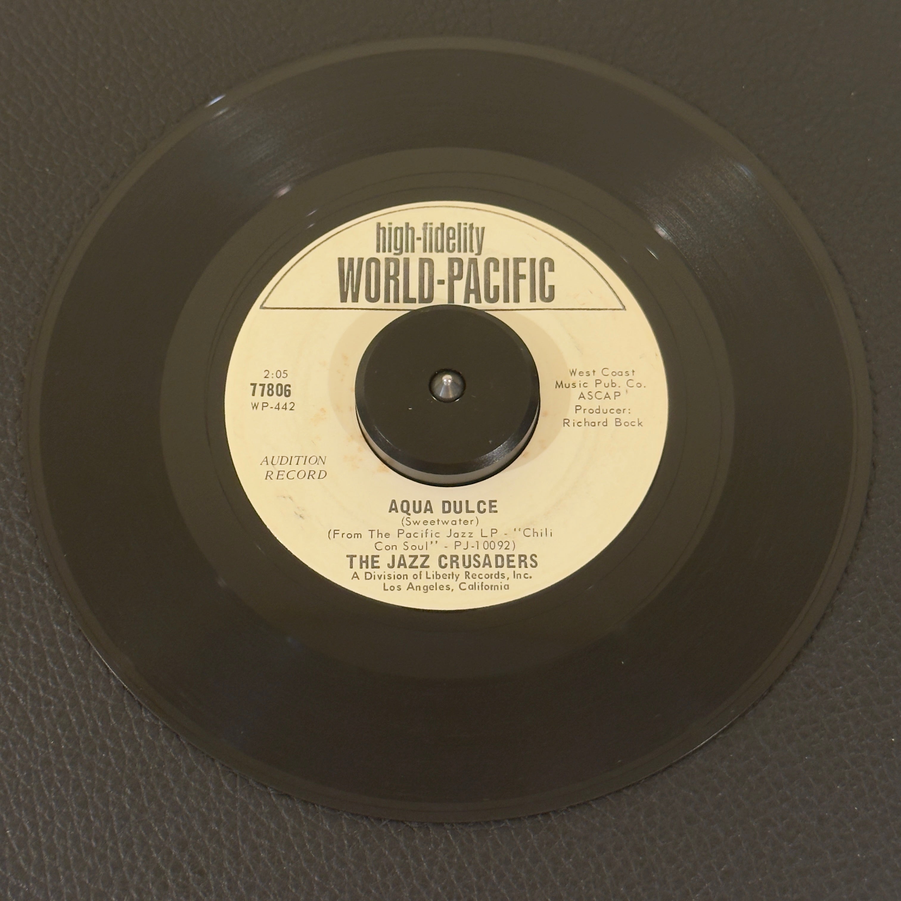 7" vinyl record by Jazz Crusaders, The featuring "Aqua Dulce/Soul Bourgeoisie", released on World Pacific Records (77806), in VG+ (Very Good Plus) condition, classic analog collectable for turntable playback. Original 1966 World Pacific Records Promotional Copy of a beautifully preserved artifact of 1960s soul-jazz history.