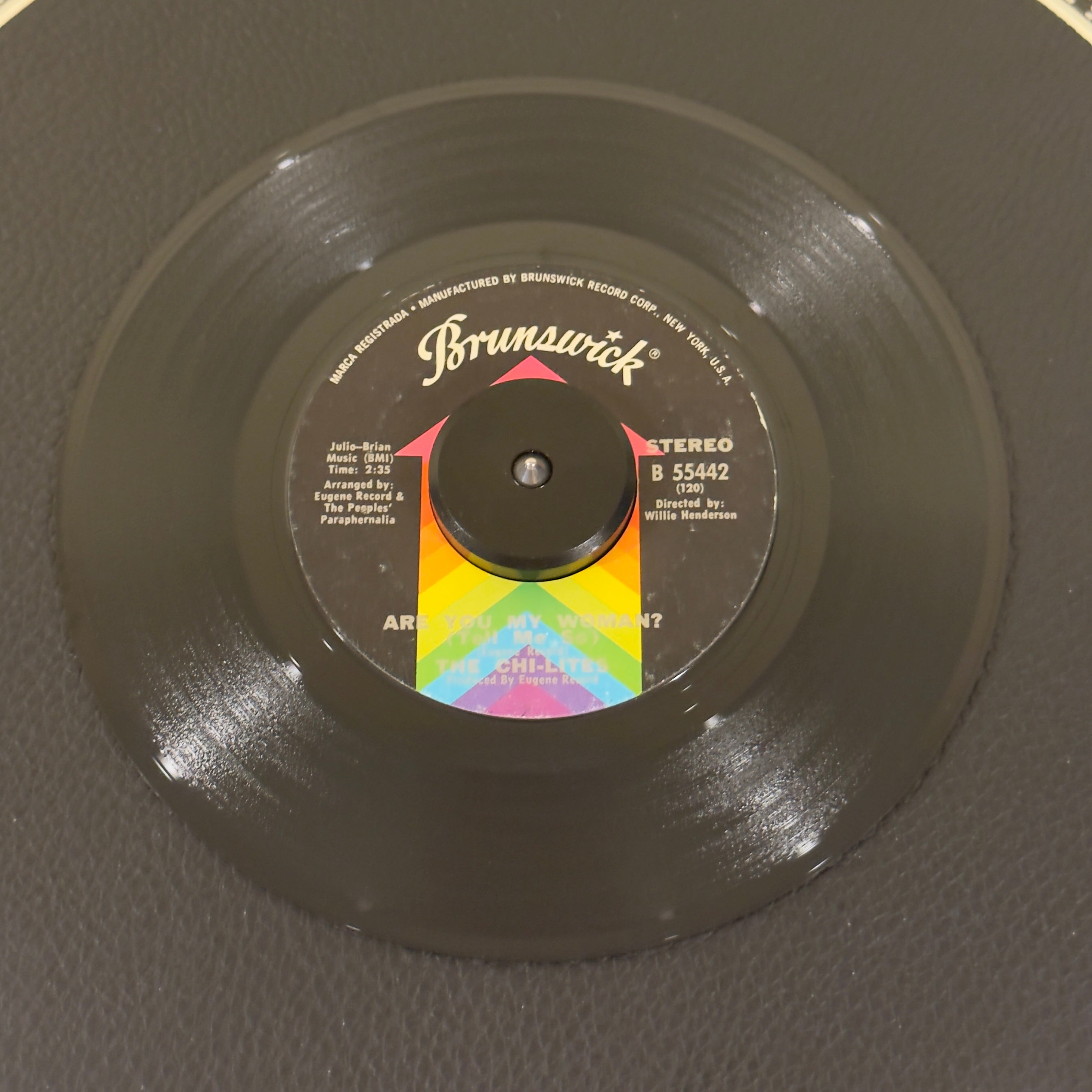 7" vinyl record by Chi-Lites, The featuring "Are You My Woman? /Troubles A' Comin", released on Brunswick (B 55442), in VG (Very Good) condition, classic analog collectable for turntable playback. Famed worldwide for its explosive, triumphant brass fanfare, this 1970 banger served as the loop and foundational backing track for Beyoncé and Jay-Z's multi-platinum global hit "Crazy in Love."