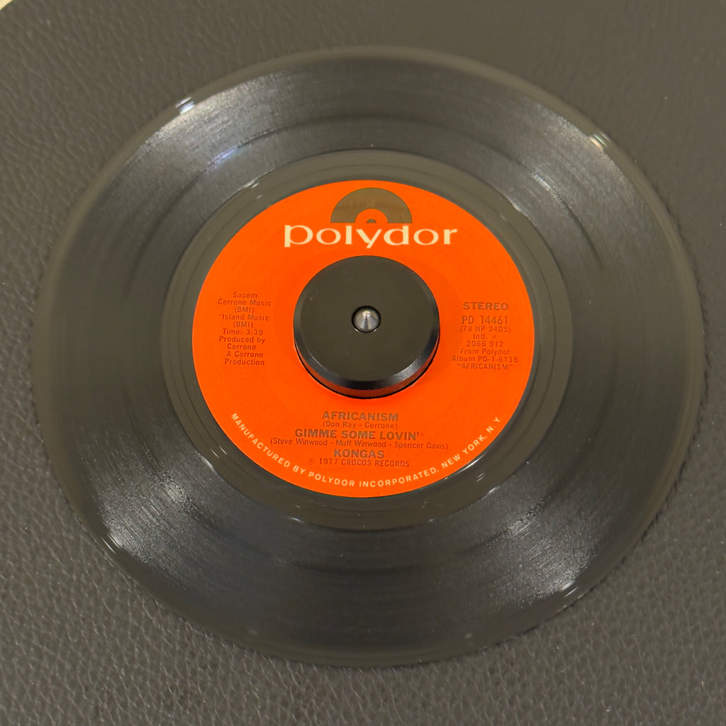 7" vinyl record by Kongas featuring "Africanism / Give Me Some Lovin'/Tatoo Woman", released on Polydor (PD 14461), in VG+ (Very Good Plus) condition, classic analog collectable for turntable playback. High-octane 1977 Euro-disco and Afro-rock energy produced by the godfather of French disco, Cerrone.  Original Polydor sleeve included.