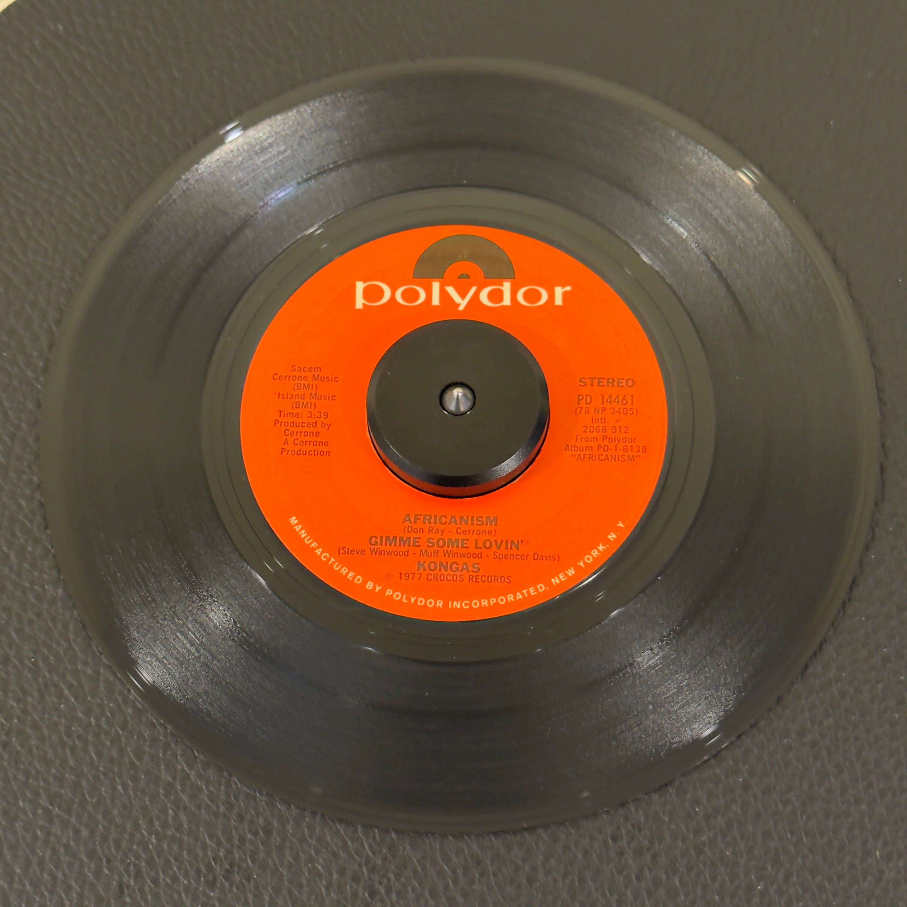 7" vinyl record by Kongas featuring "Africanism / Give Me Some Lovin'/Tatoo Woman", released on Polydor (PD 14461), in VG+ (Very Good Plus) condition, classic analog collectable for turntable playback. High-octane 1977 Euro-disco and Afro-rock energy produced by the godfather of French disco, Cerrone.  Original Polydor sleeve included.