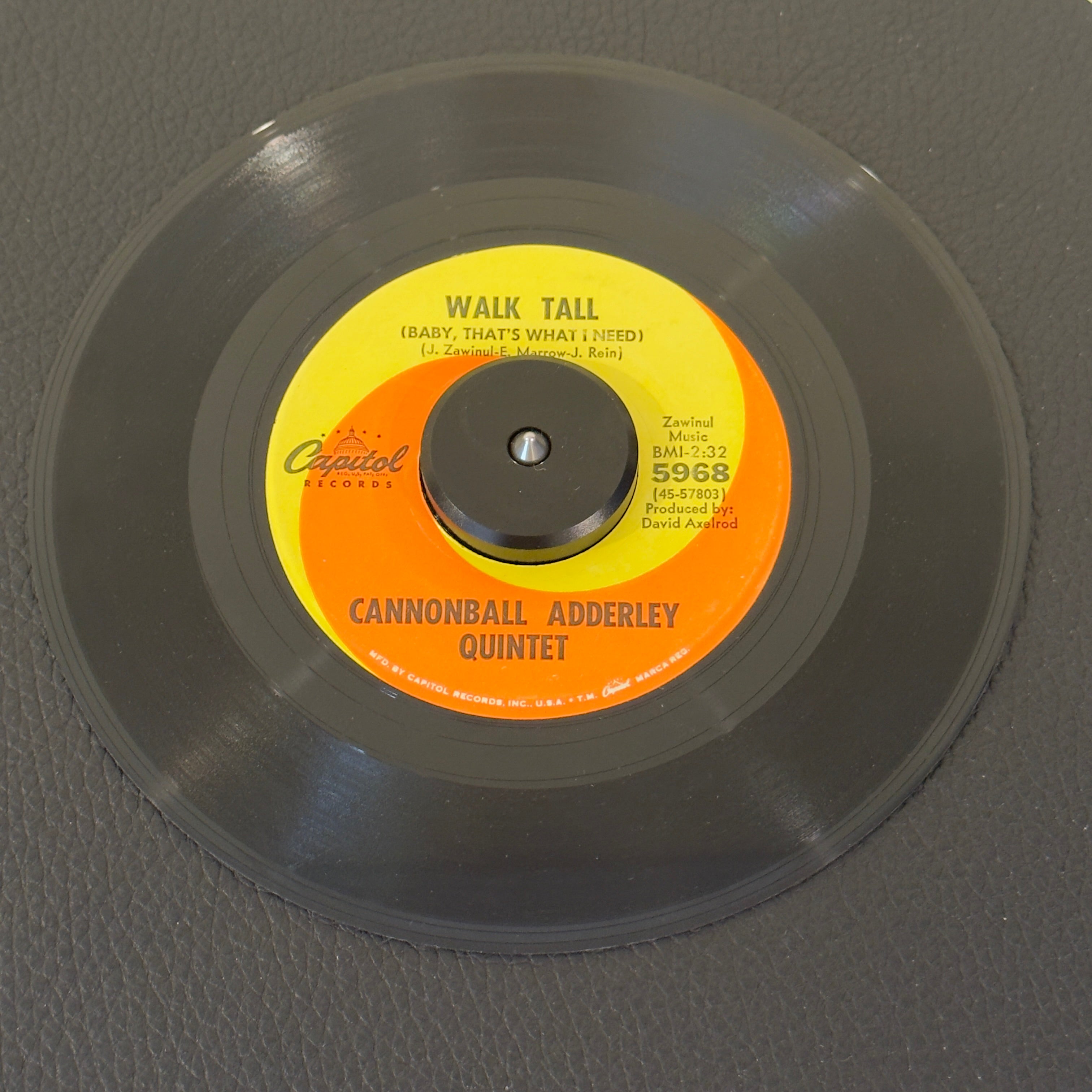 7" vinyl record by Cannonball Adderley Quintet featuring "Walk Tall (Baby, That's What I Need)/Do Do Do (What Now Is Next)", released on Capitol Records (5968), in VG+ (Very Good Plus) condition, classic analog collectable for turntable playback. Co-written by jazz legend Joe Zawinul , this track perfectly balances modal jazz sophistication with a heavy R&B backbeat. Orig. Capitol sleeve.