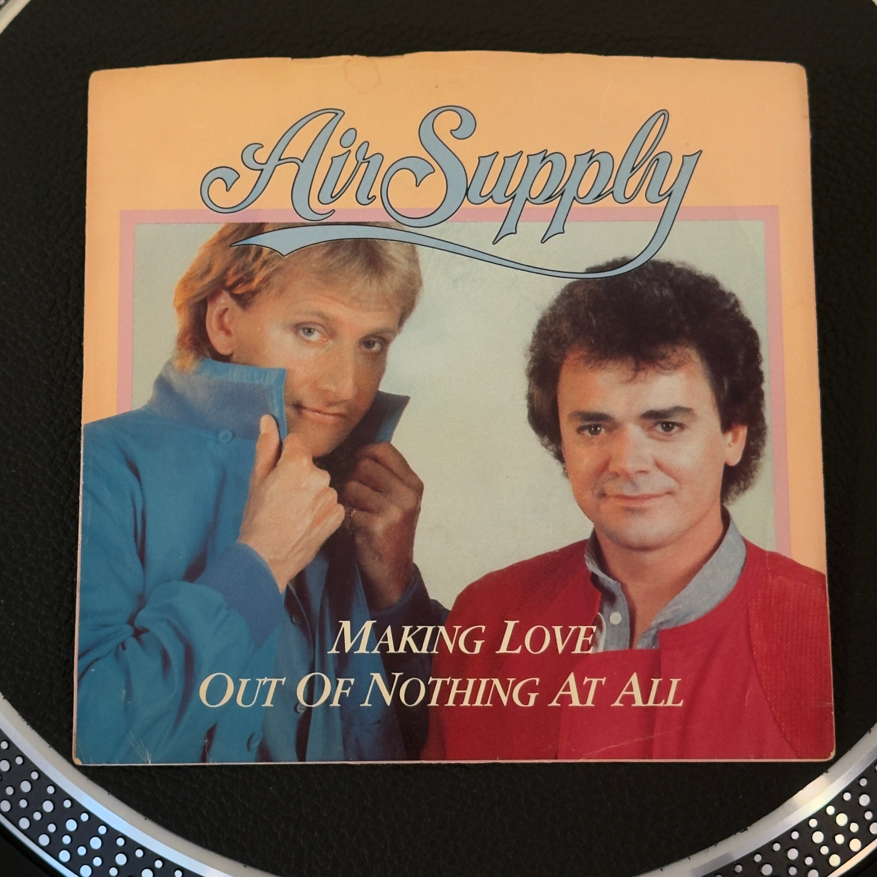 7" vinyl record by Air Supply featuring "Making Love Out Of Nothing At All/Late Again (Live Version)", released on Arista (AS 1 9056), in NM (Near Mint) condition, classic analog collectable for turntable playback. Experience the ultimate peak of 1980s power balladry in pristine, archive-quality condition! Pic sleeve included.