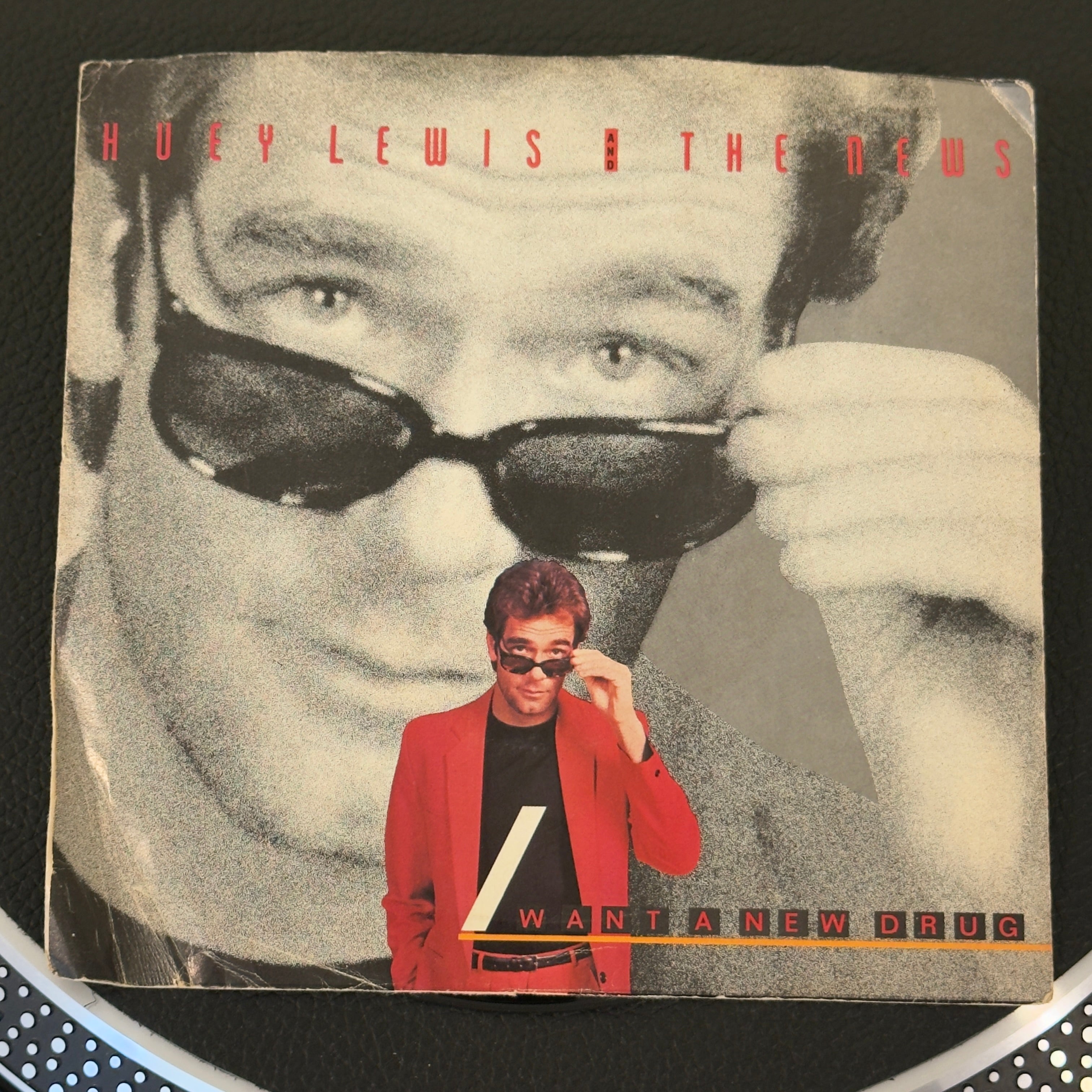 7" vinyl record by Huey Lewis and The News featuring "I Want A New Drug/Finally Found A Home", released on Chrysalis (VS4 42766), in VG+ (Very Good Plus) condition, classic analog collectable for turntable playback. Famous for its driving bassline, punchy brass accents, and unforgettable guitar hooks, this track remains an absolute high-water mark of 1980s rock & roll. Pic sleeve inc.