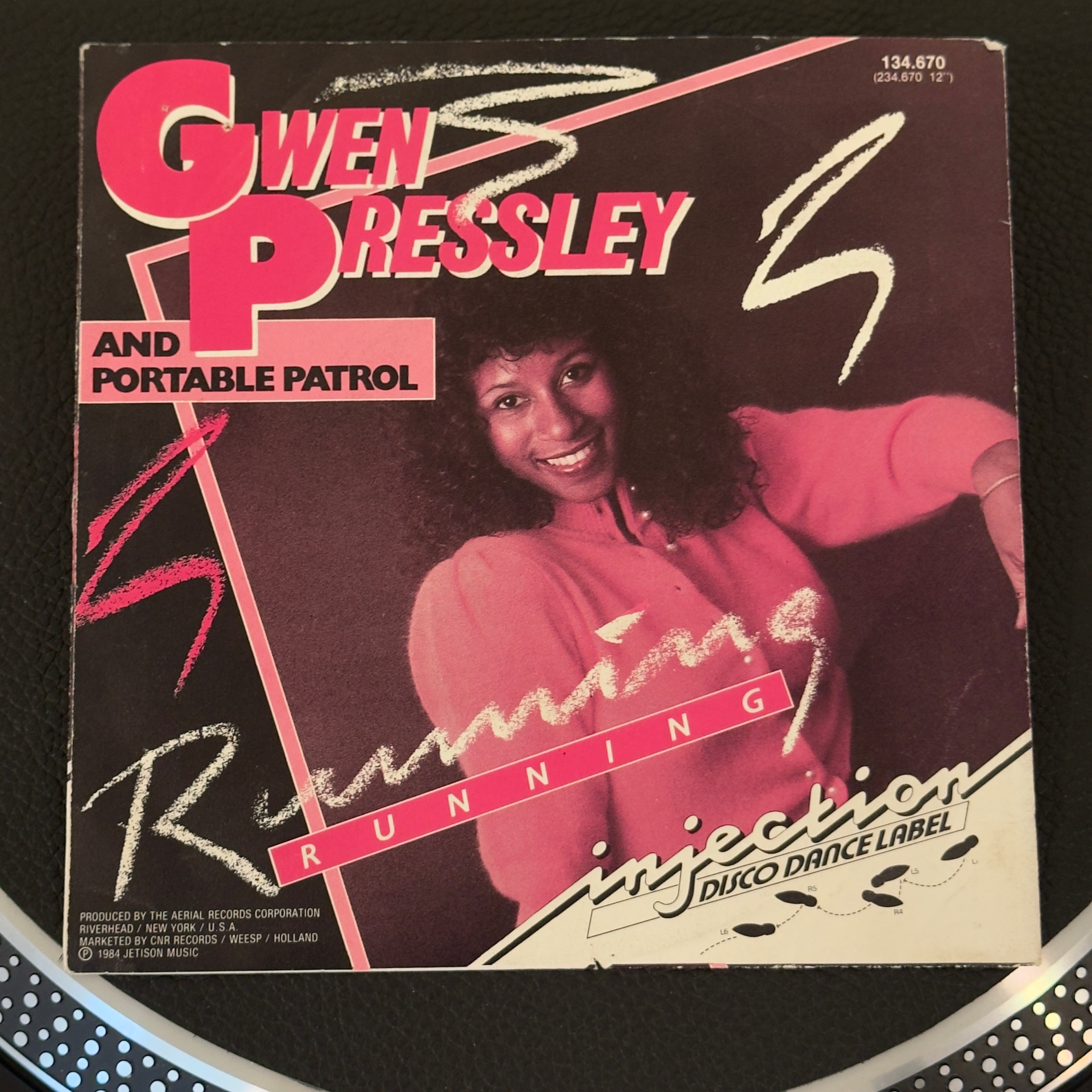 7" vinyl record by Gwen Pressley and Portable Patrol featuring "Running/(Short Dub Version)", released on Injection Disco Dance Label (134.670), in NM (Near Mint) condition, classic analog collectable for turntable playback. Netherlands pressing of an elusive piece of mid-1980s Euro-disco and Hi-NRG history!  Pic sleeve included.