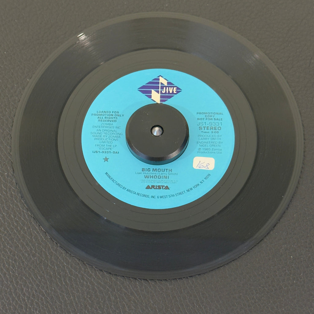 7" vinyl record by Whodini featuring "Big Mouth/Big Mouth", released on Jive (JS1-9331), in VG+ (Very Good Plus) condition, classic analog collectable for turntable playback. Promo copy of this 1985 banger famous for its sharp lyricism, punchy early beatbox cadences, and heavy electronic synthesizer lines, this track is an absolute milestone of 1980s East Coast rap music.