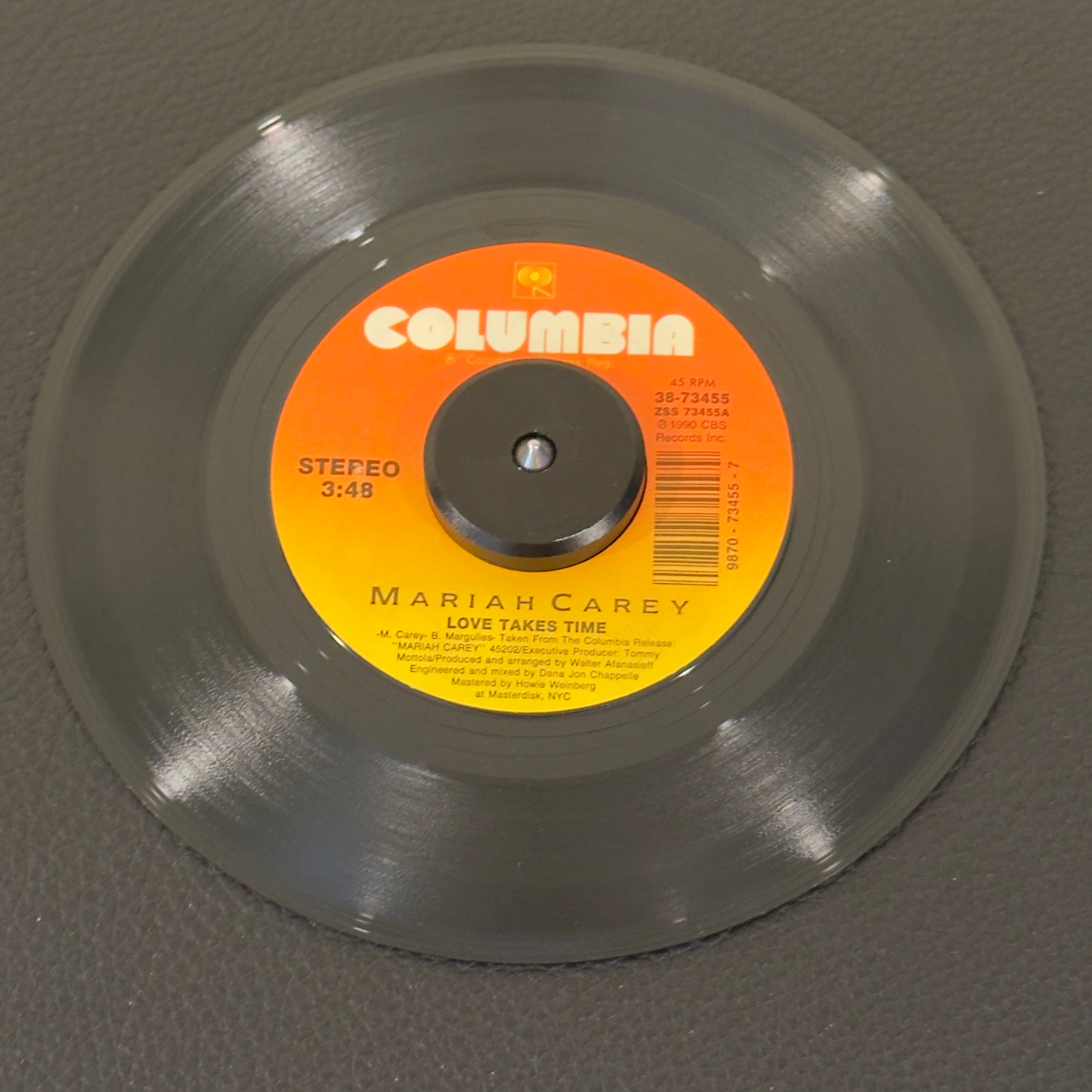 7" vinyl record by Mariah Carey featuring "Love Takes Time/Sent From Up Above", released on Columbia (38-73455), in NM (Near Mint) condition, classic analog collectable for turntable playback. Absolutely flawless piece of 14990 vocal pop history!