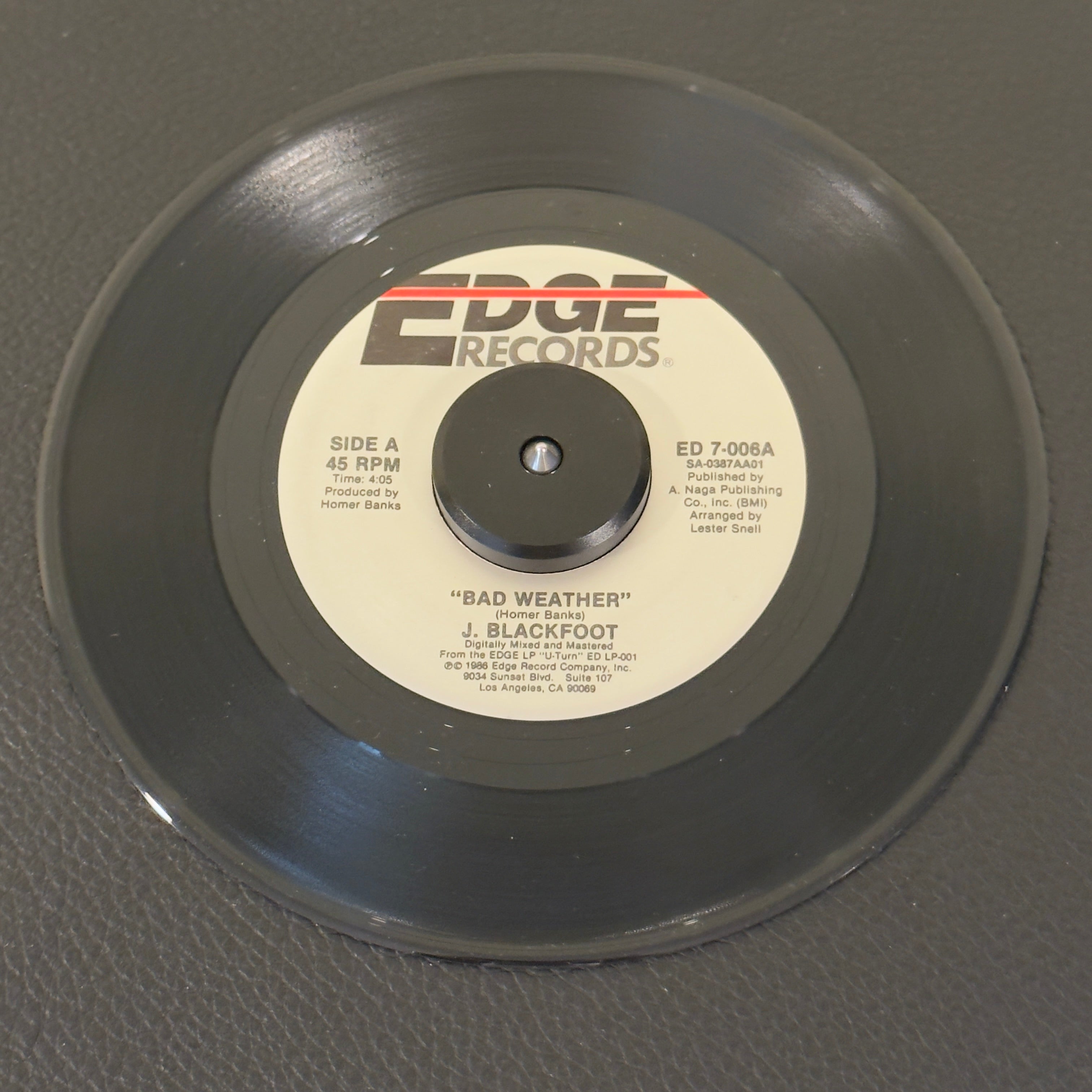 7" vinyl record by J. Blackfoot featuring "Bad Weather/Friendship", released on Edge Records (ED 7-006), in NM (Near Mint) condition, classic analog collectable for turntable playback. "Bad Weather" remains a highly sought-after track for classic R&B enthusiasts and southern soul DJs.
