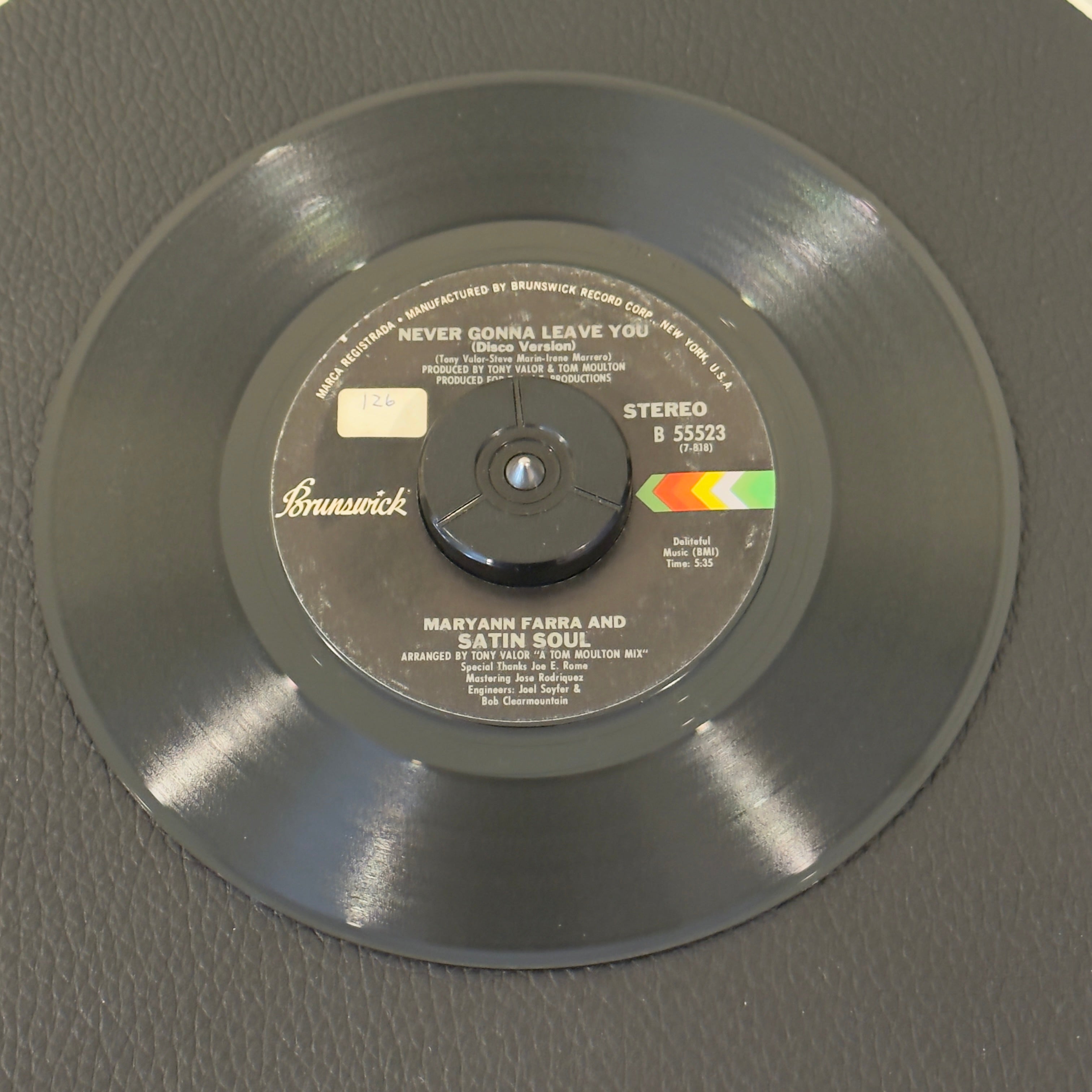 7" vinyl record by Maryann Farra & Satin Soul featuring "Never Gonna Leave You/Never Gonna Leave You (Disco Version)", released on Brunswick (B 55523), in VG+ (Very Good Plus) condition, classic analog collectable for turntable playback. Sticker on Label (Side B)