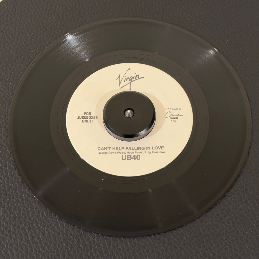 7" vinyl record by UB40 featuring "Can't Help Falling In Love/Jungle Love", released on Virgin (S7-17402), in VG+ (Very Good Plus) condition, classic analog collectable for turntable playback. Highly collectible US jukebox 7" pressing of this brilliant reggae-pop reimagining of the Elvis Presley classic dominated airwaves and defined the soundtrack to the hit film Sliver.