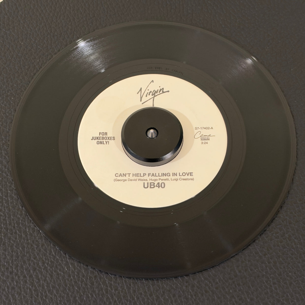 7" vinyl record by UB40 featuring "Can't Help Falling In Love/Jungle Love", released on Virgin (S7-17402), in VG+ (Very Good Plus) condition, classic analog collectable for turntable playback. Highly collectible US jukebox 7" pressing of this brilliant reggae-pop reimagining of the Elvis Presley classic dominated airwaves and defined the soundtrack to the hit film Sliver.