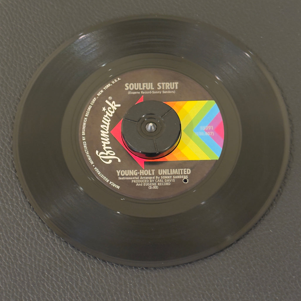 7" vinyl record by Young-Holt Unlimited featuring "Soulful Strut/Country Slicker Joe", released on Brunswick (55391), in NM (Near Mint) condition, classic analog collectable for turntable playback. Pinckneyville Pressing. Includes Brunswick sleeve. Punch hole in label.