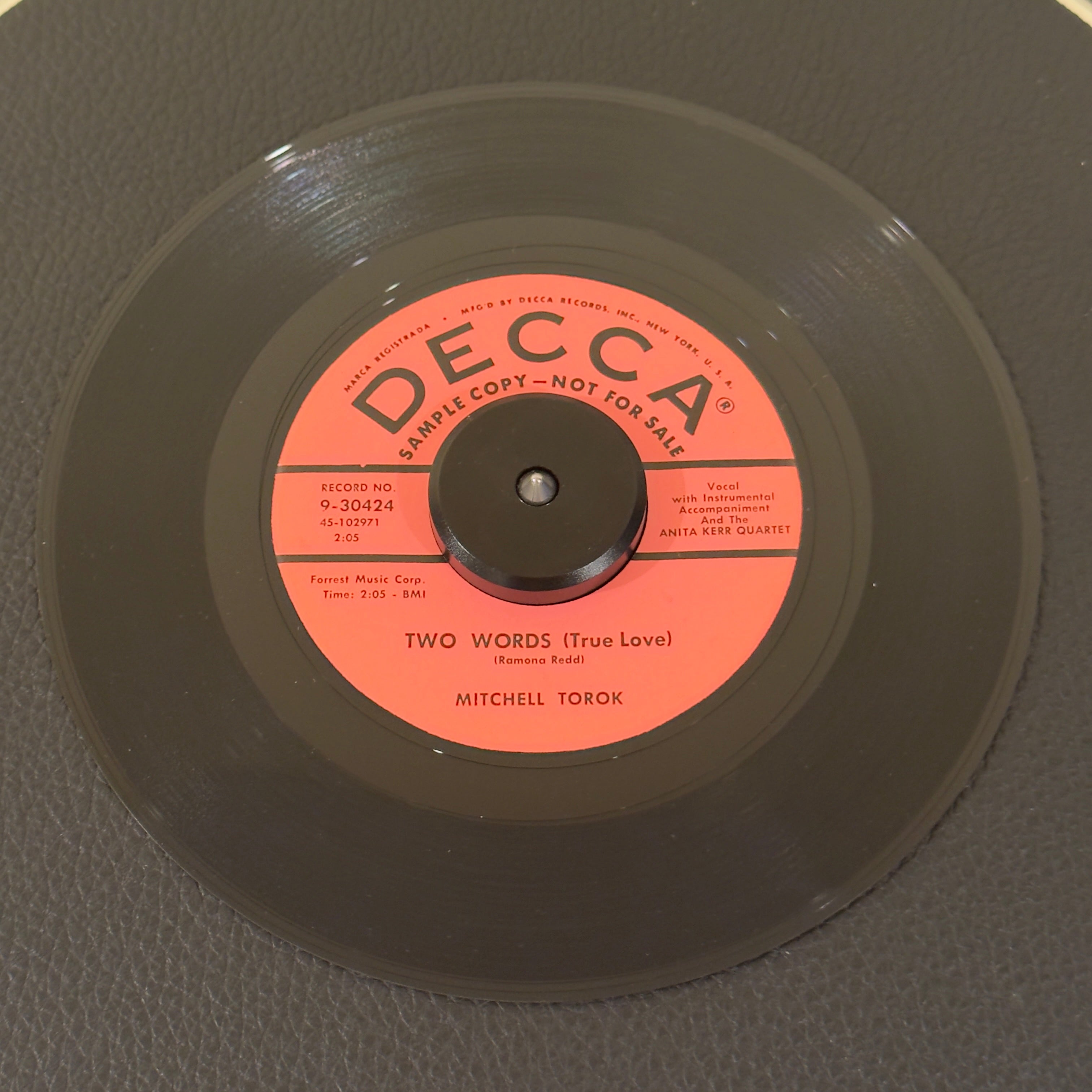 7" vinyl record by Mitchell Torok featuring "Two Words (True Love)/You're Tempting Me", released on Decca (9-30424), in NM (Near Mint) condition, classic analog collectable for turntable playback. Promo copy with the Decca sleeve!