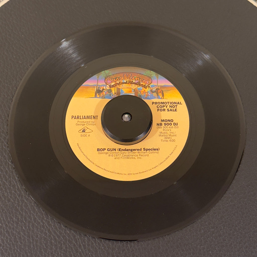 7" vinyl record by Parliament featuring "Bop Gun (Endangered Species) Mono", released on Casablanca (NB900DJ), in NM (Near Mint) condition, classic analog collectable for turntable playback. Original 1977 US radio station promotional pressing of the definitive P-Funk classic in the original Casablanca sleeve.