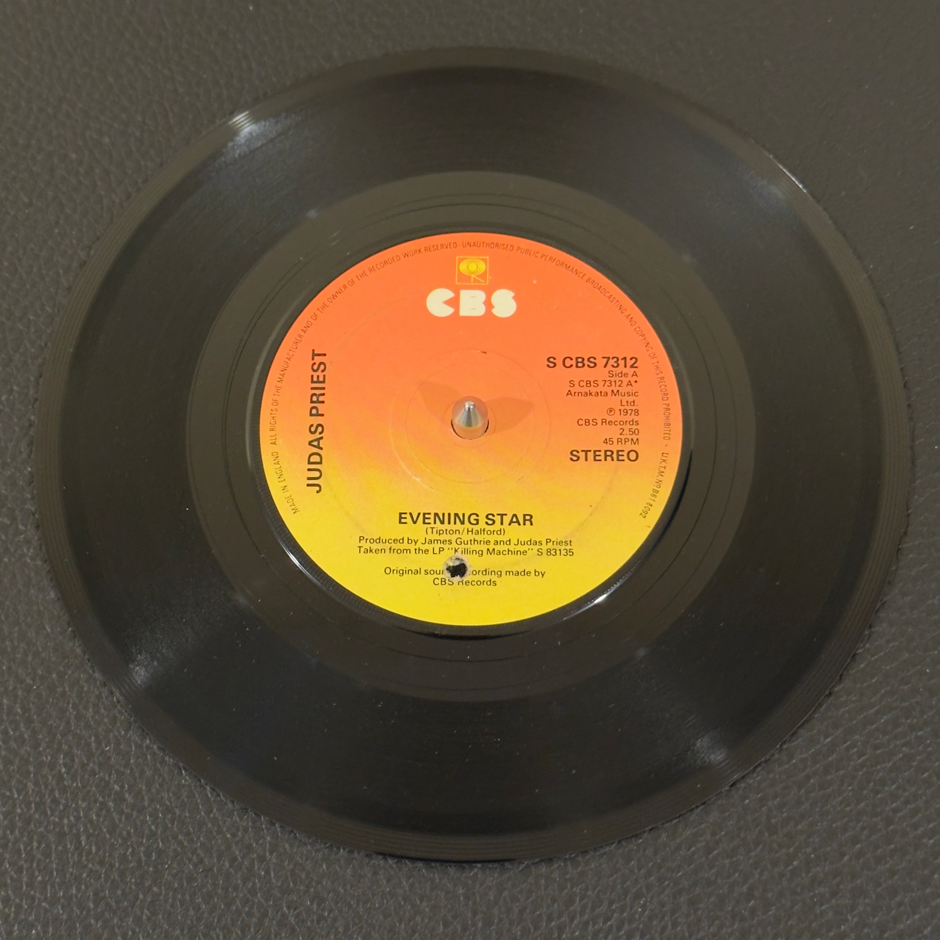 7" vinyl record by Judas Priest featuring "Evening Star/Beyond The Realms of Death", released on CBS (S CBS 7312), in VG (Very Good) condition, classic analog collectable for turntable playback. UK Pressing. Punch hole in label.