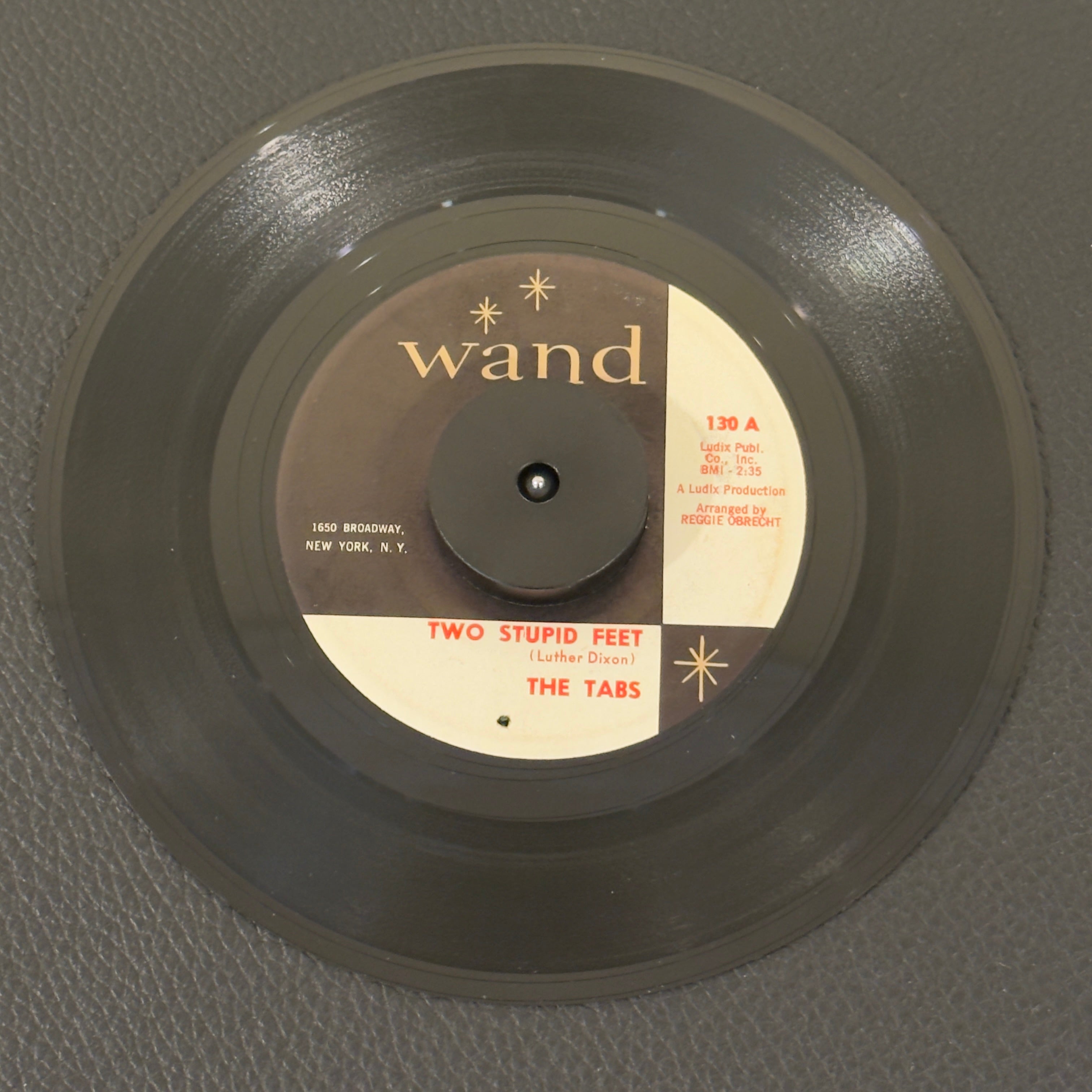 7" vinyl record by Tabs, The featuring "Two Stupid Feet/The Wallop", released on Wand (130), in VG (Very Good) condition, classic analog collectable for turntable playback. 1st Pressing with "Two Stupid Feet" on Side A.  Original Wand sleeve included.