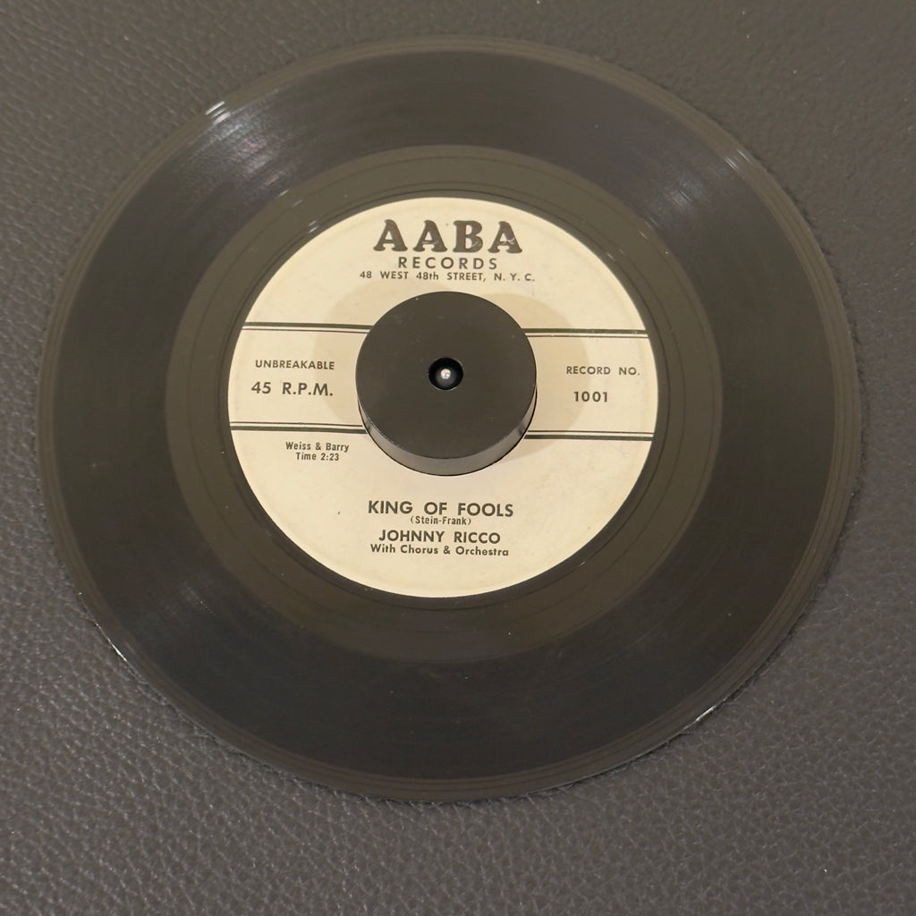 7" vinyl record by Johhny Ricco featuring "King Of Fools/I'll Never Smile Again", released on AABA Records (1001 / 1002), in VG (Very Good) condition, classic analog collectable for turntable playback.