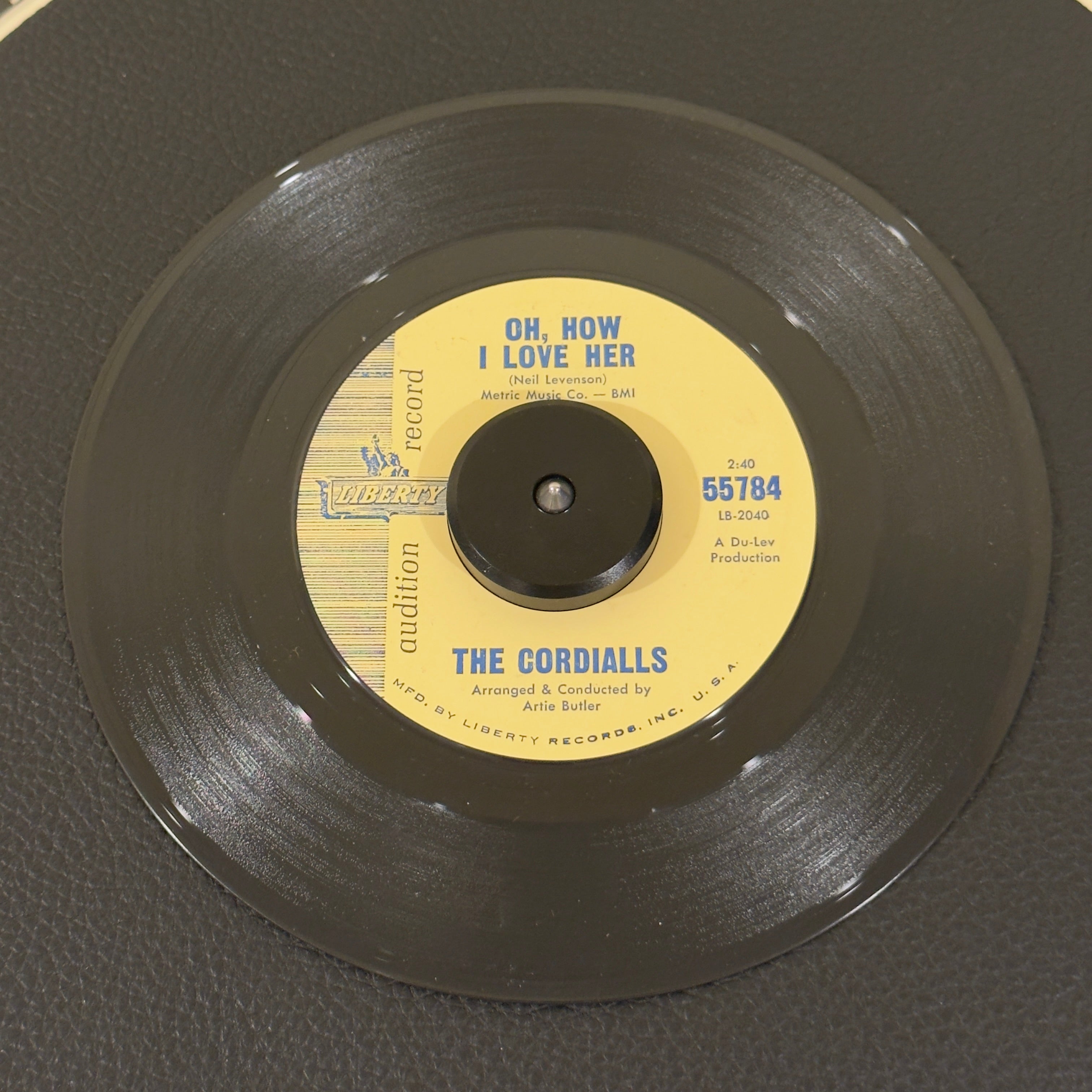 7" vinyl record by Cordialls, The featuring "Oh, How I Love Her/You Can't Believe In Love", released on Liberty (55784), in VG+ (Very Good Plus) condition, classic analog collectable for turntable playback. Audition Record of a mid-1960s harmony track bridging late doo-wop vocal structures with emerging Northern Soul/Pop-Rock styles. Writing on label (Side B).